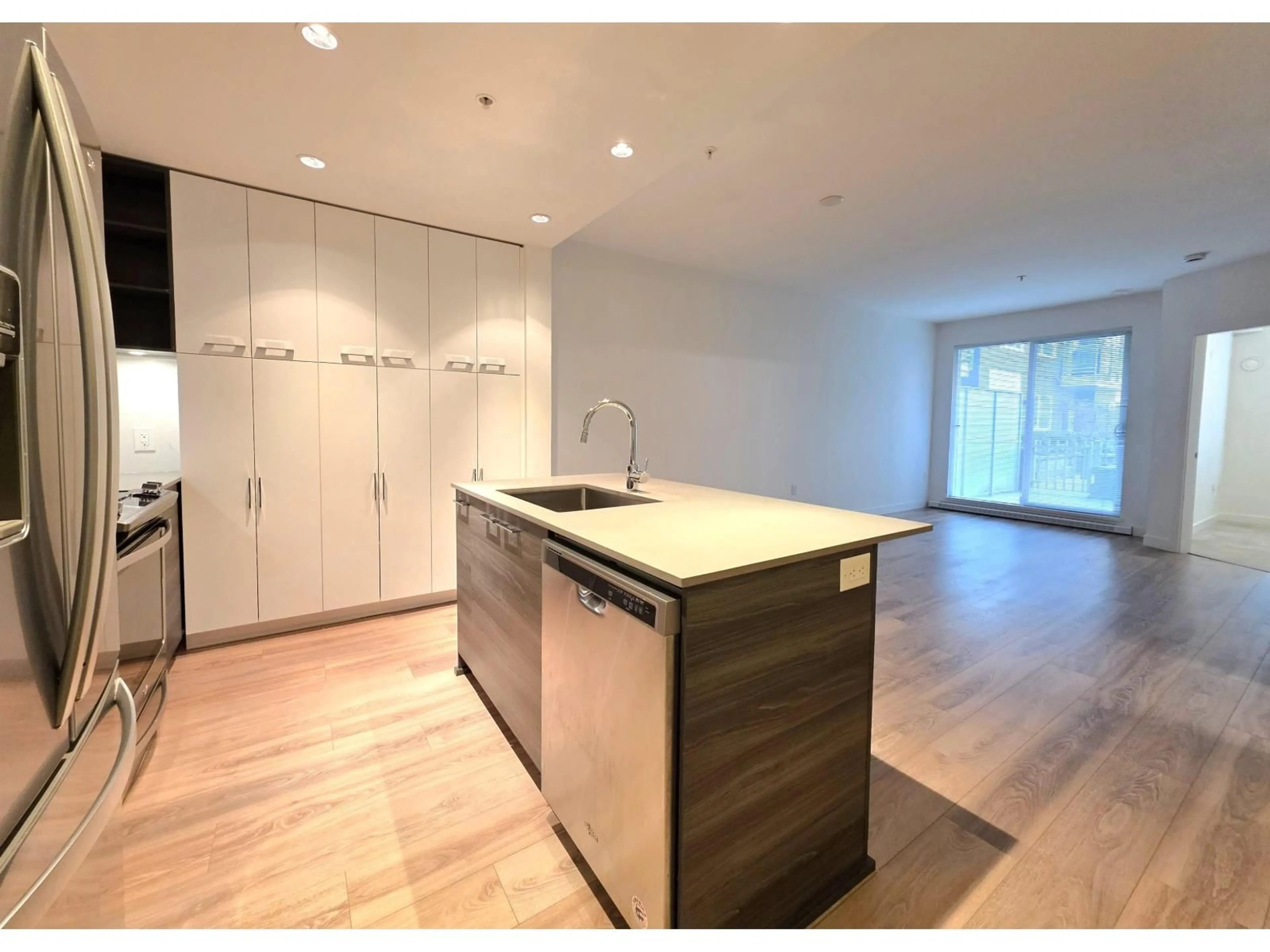 Open concept kitchen, wood/laminate floor for 104 - 10581 140 STREET, Surrey British Columbia V3T0M7
