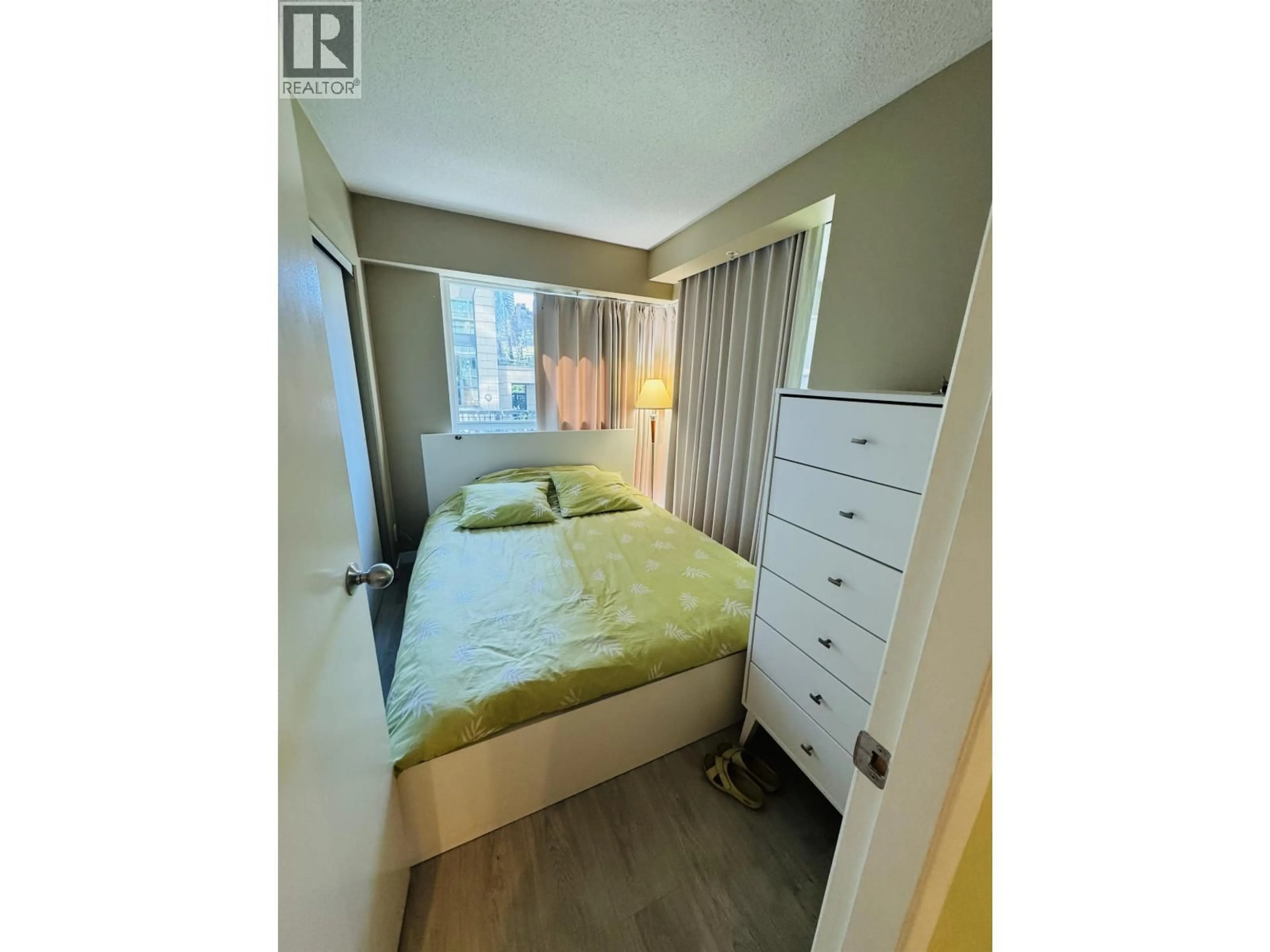 Bedroom with bed, wood/laminate floor for 207 - 1889 ALBERNI STREET, Vancouver British Columbia V6G3G7
