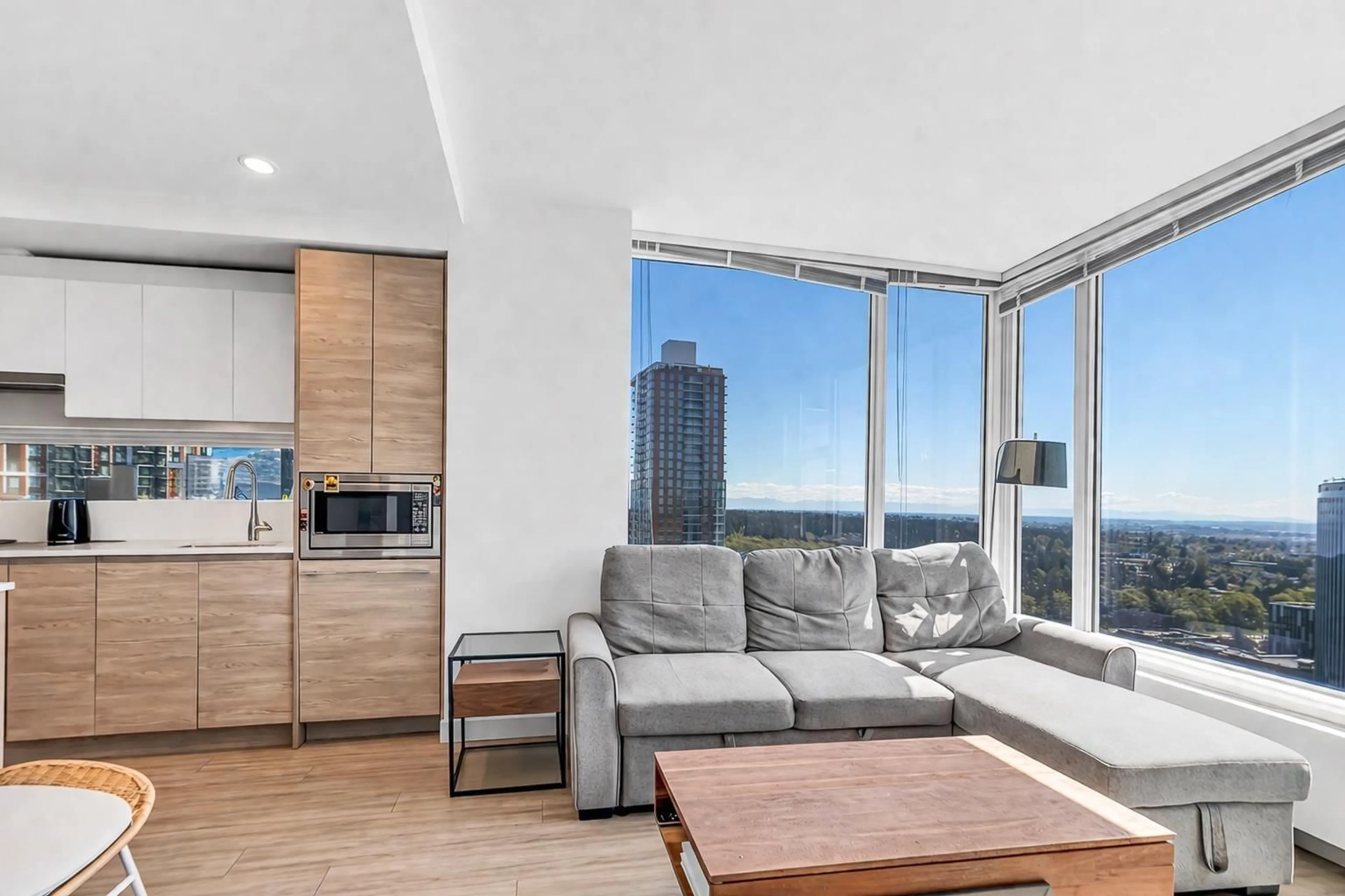 Living room with furniture, wood/laminate floor for 2710 - 13615 FRASER HIGHWAY, Surrey British Columbia V3T0P7