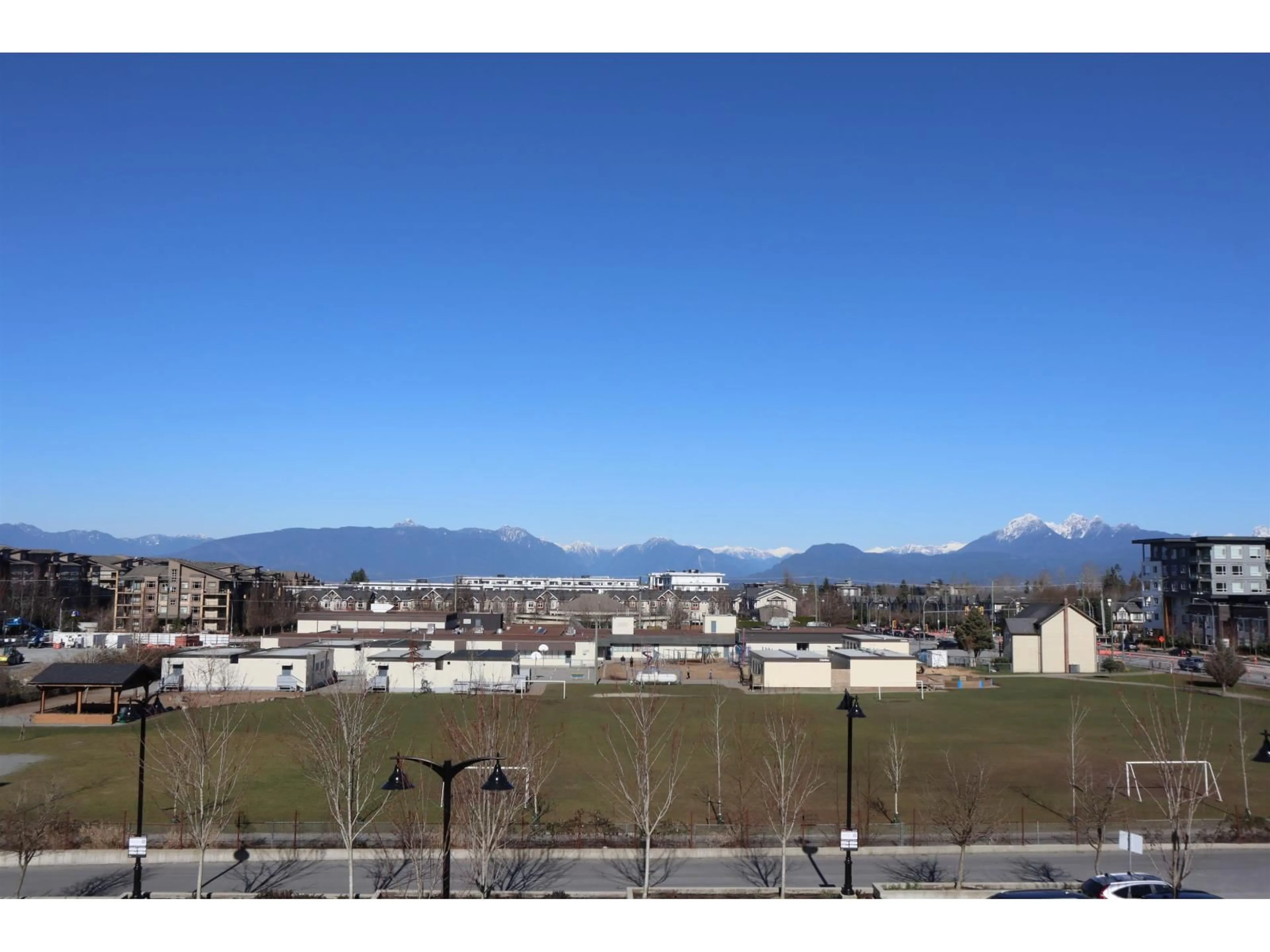 A pic from outside/outdoor area/front of a property/back of a property/a pic from drone, mountain view for A327 - 20727 WILLOUGHBY TOWN CENTRE DRIVE, Langley British Columbia V2Y3N1