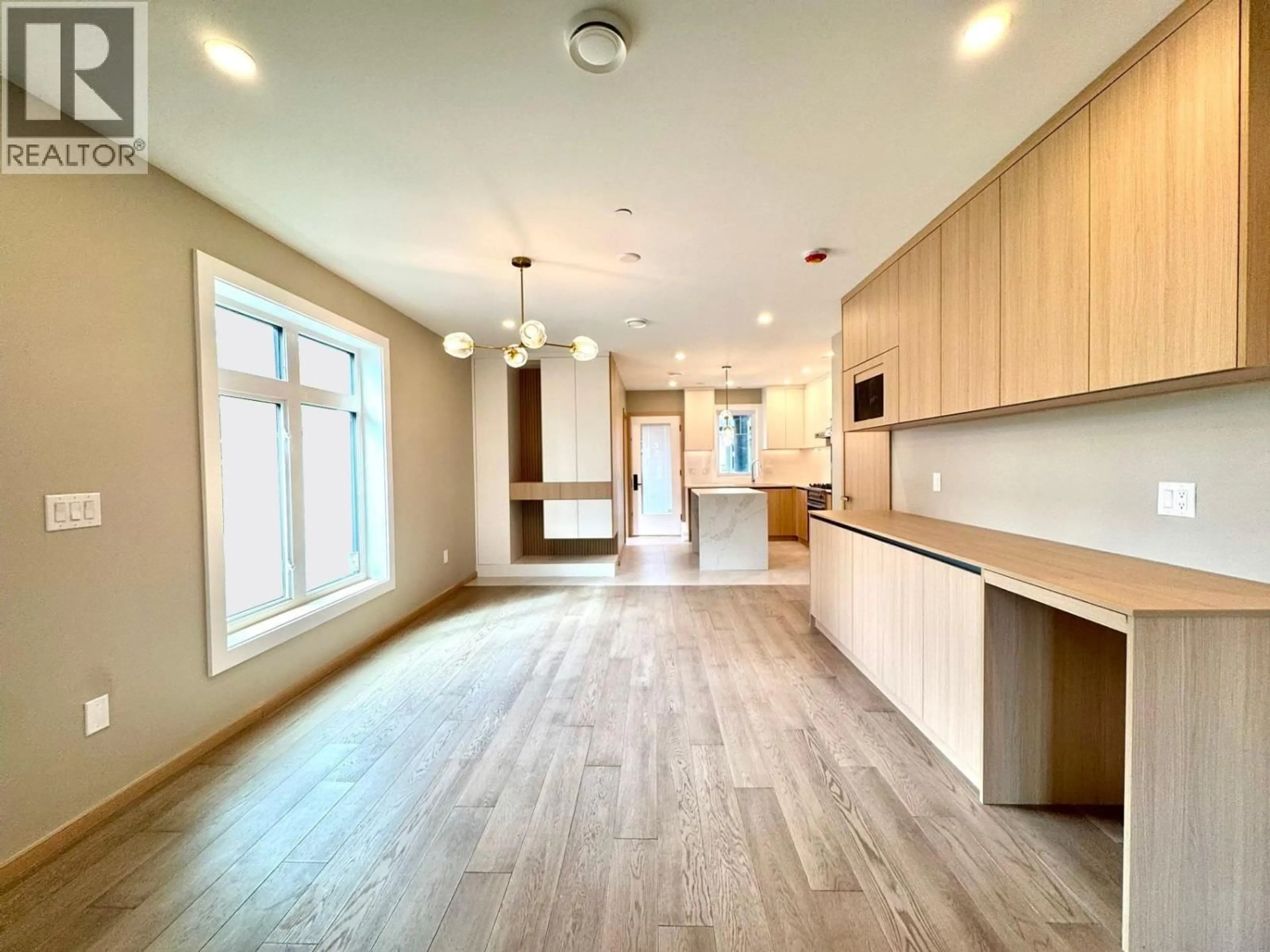 Open concept kitchen, wood/laminate floor for 5216 RUPERT STREET, Vancouver British Columbia V5R2J9