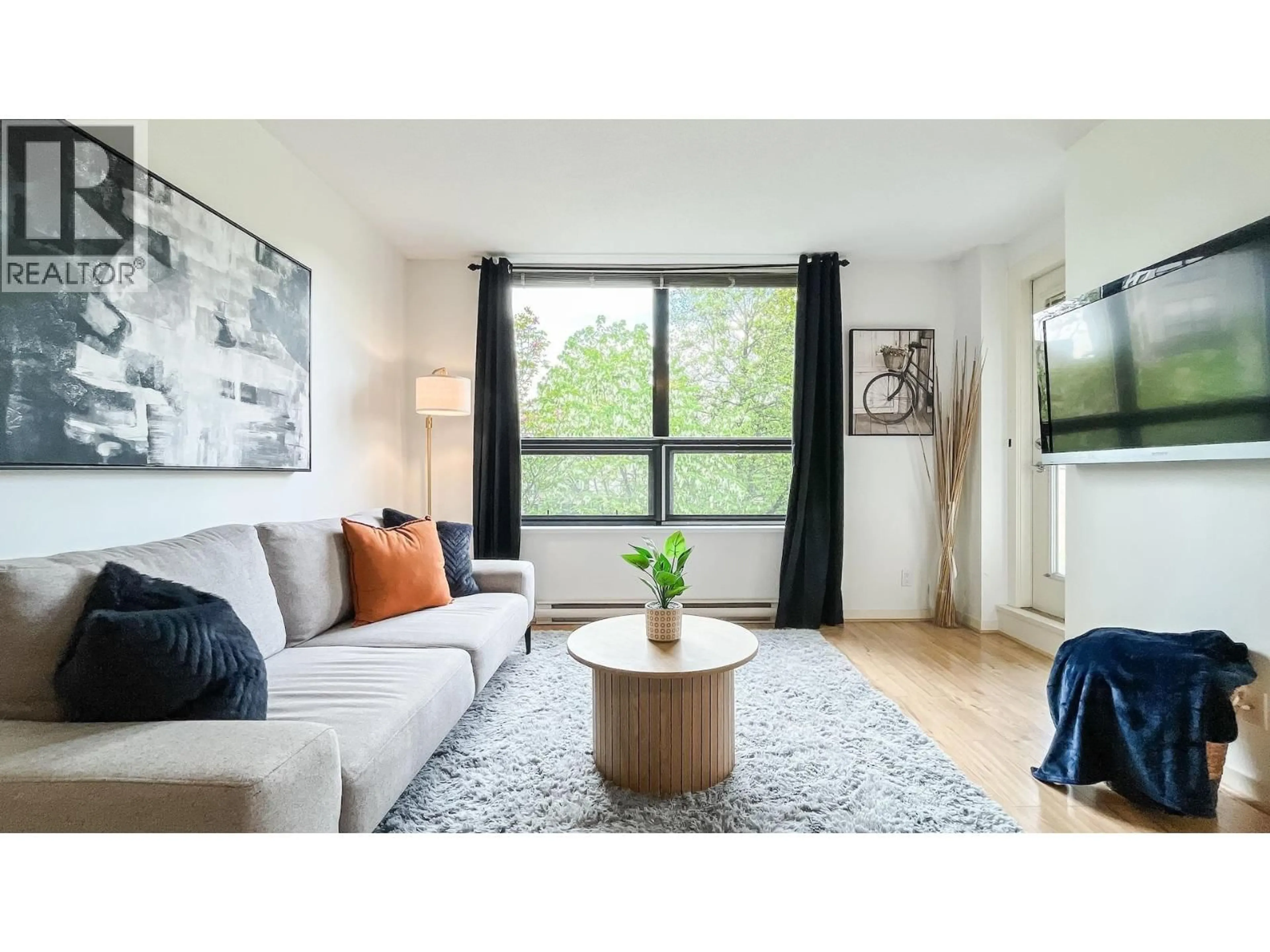 Living room with furniture, wood/laminate floor for 305 - 3638 VANNESS AVENUE, Vancouver British Columbia V5R6H6