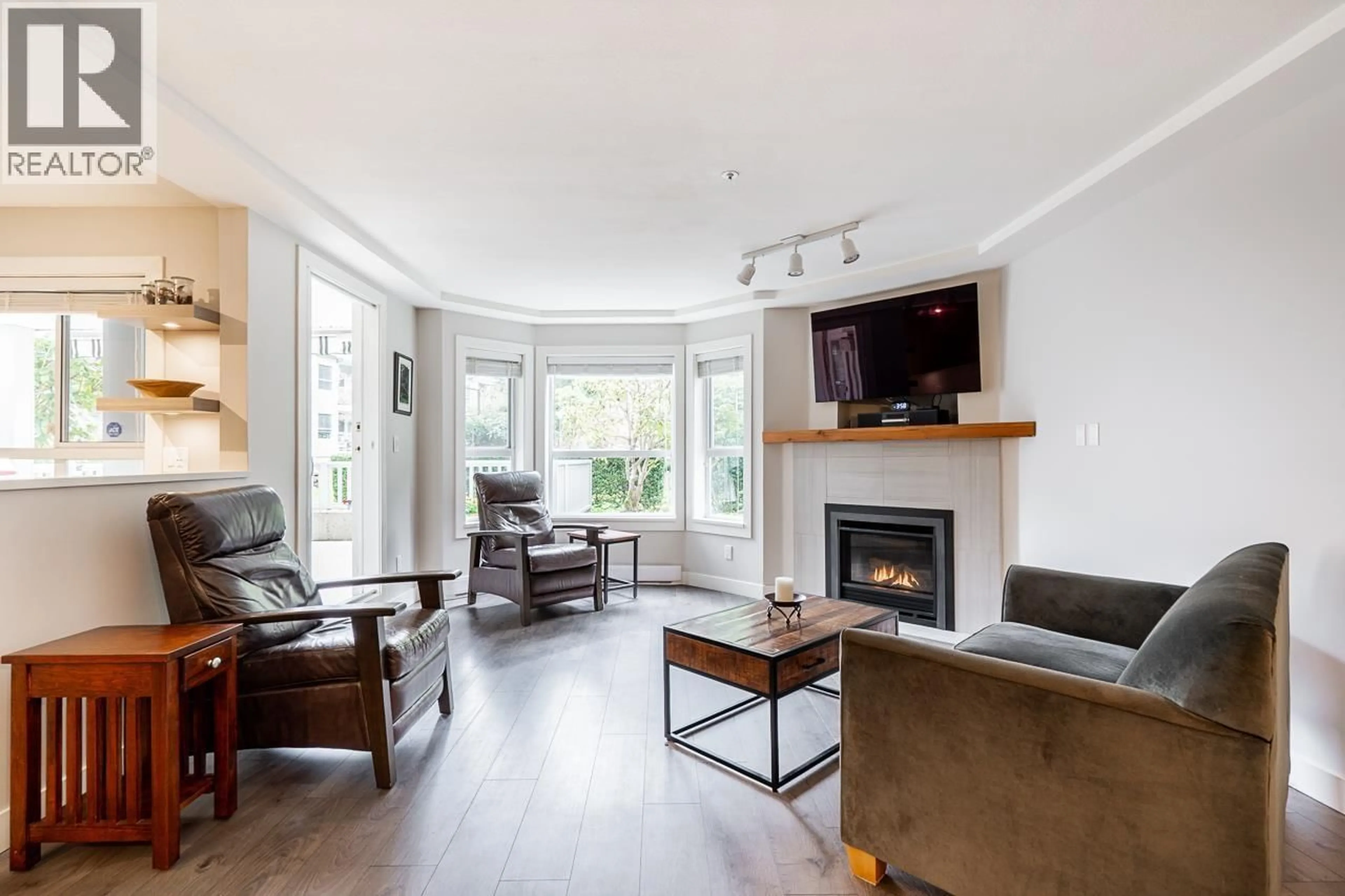 Living room with furniture, wood/laminate floor for 107 - 1283 PARKGATE AVENUE, North Vancouver British Columbia V7H3A3