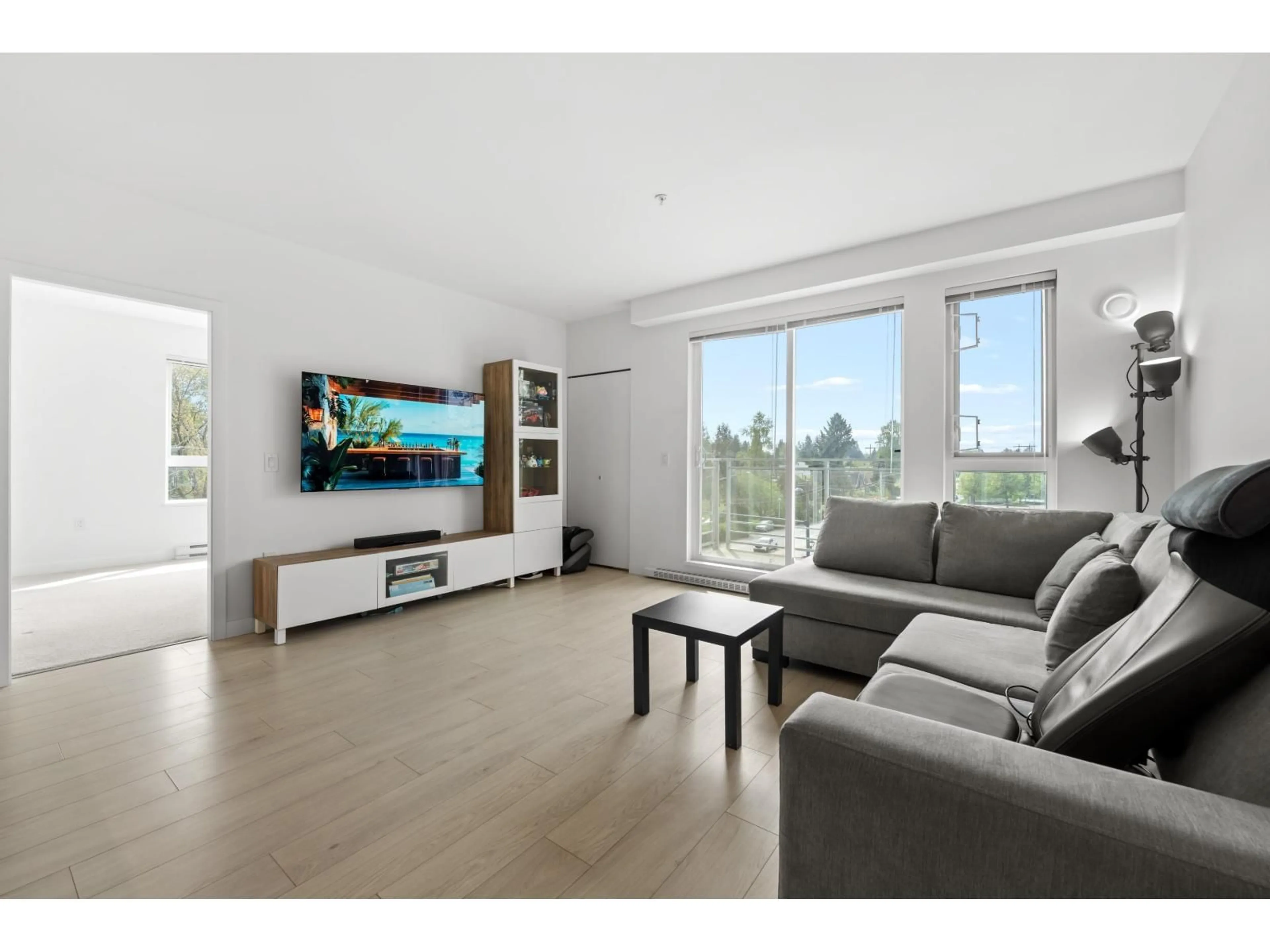 Living room with furniture, wood/laminate floor for 413 - 10581 140 STREET, Surrey British Columbia V3T0M7