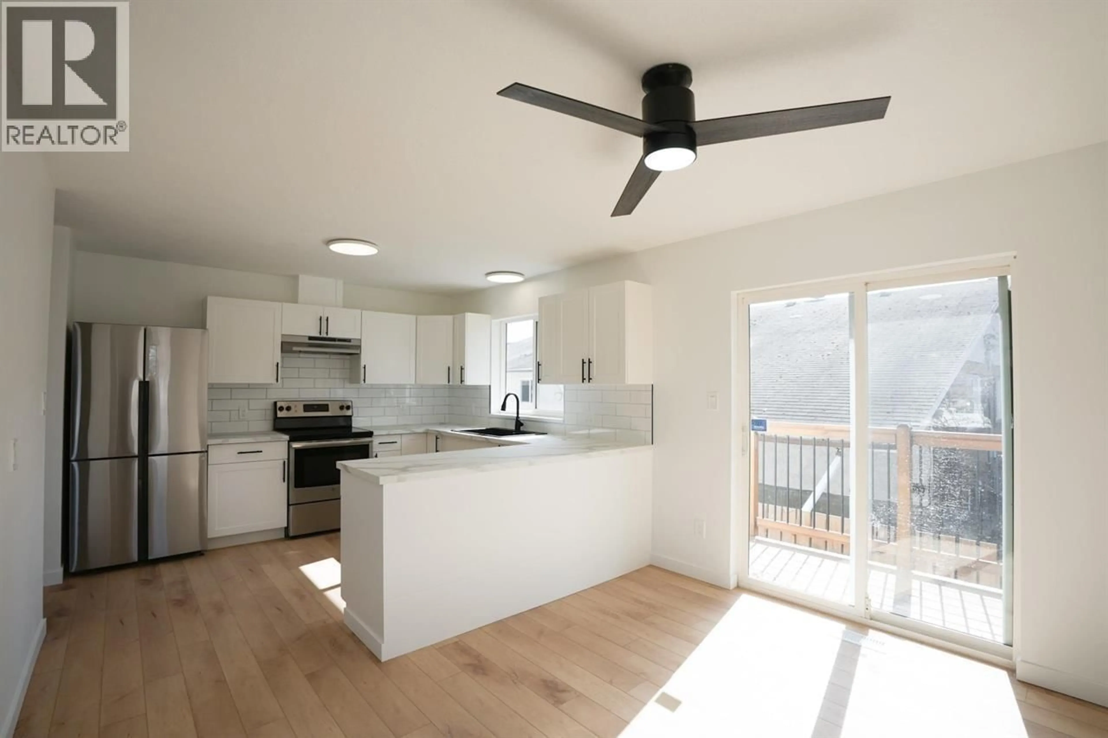 Open concept kitchen, wood/laminate floor for 1497 MCCULLAGH AVENUE, Prince George British Columbia V2L5A3