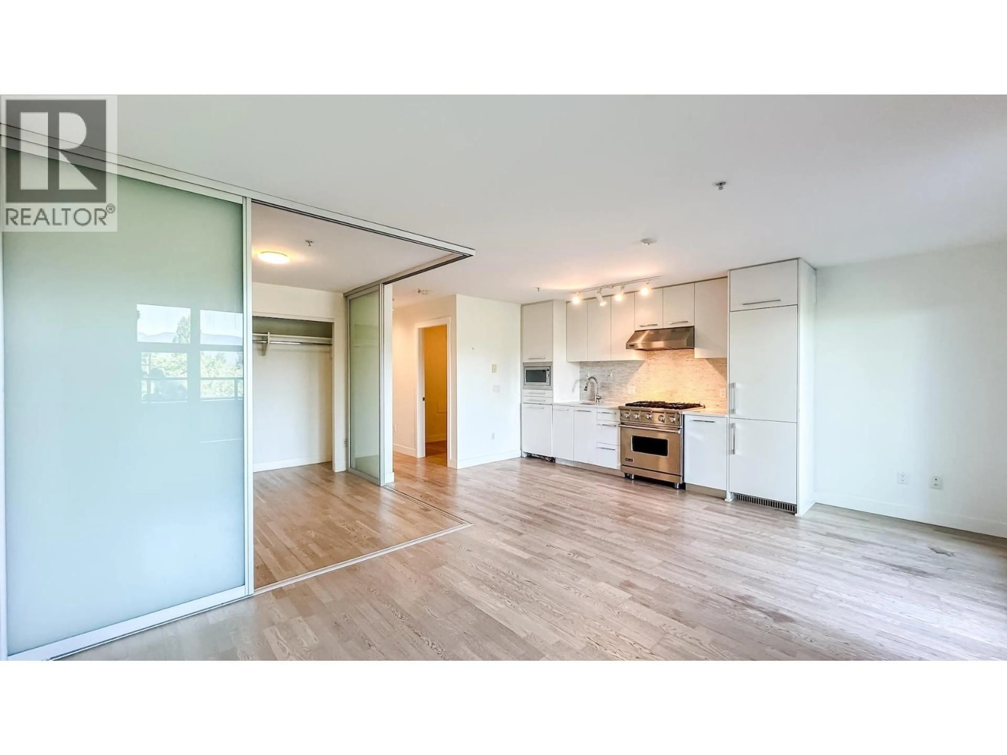 Open concept kitchen, wood/laminate floor for 202 - 4355 10TH AVENUE, Vancouver British Columbia V6R2H6