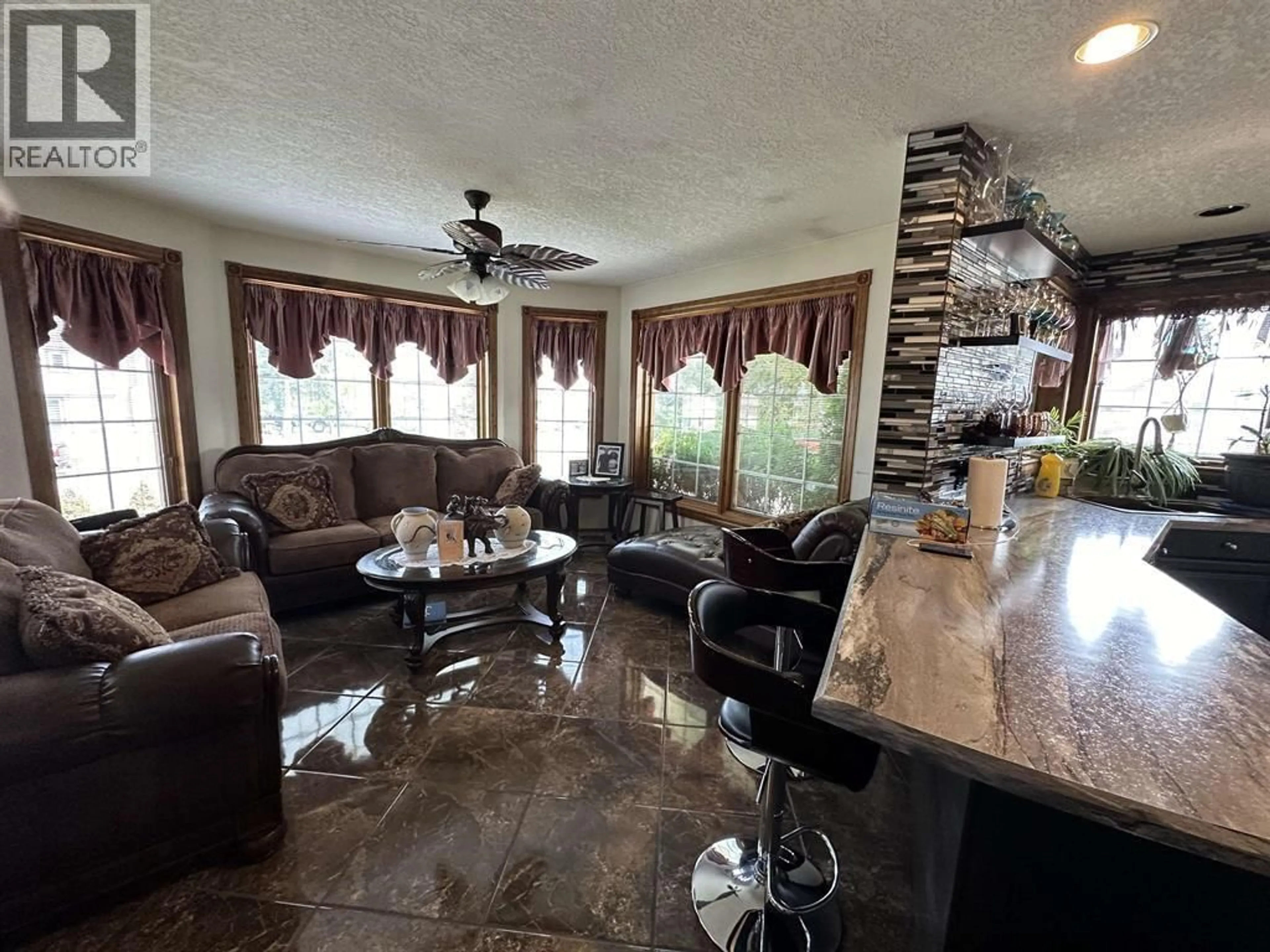 Living room with furniture, ceramic/tile floor for 10903 112 AVENUE, Fort St. John British Columbia V1J6R7