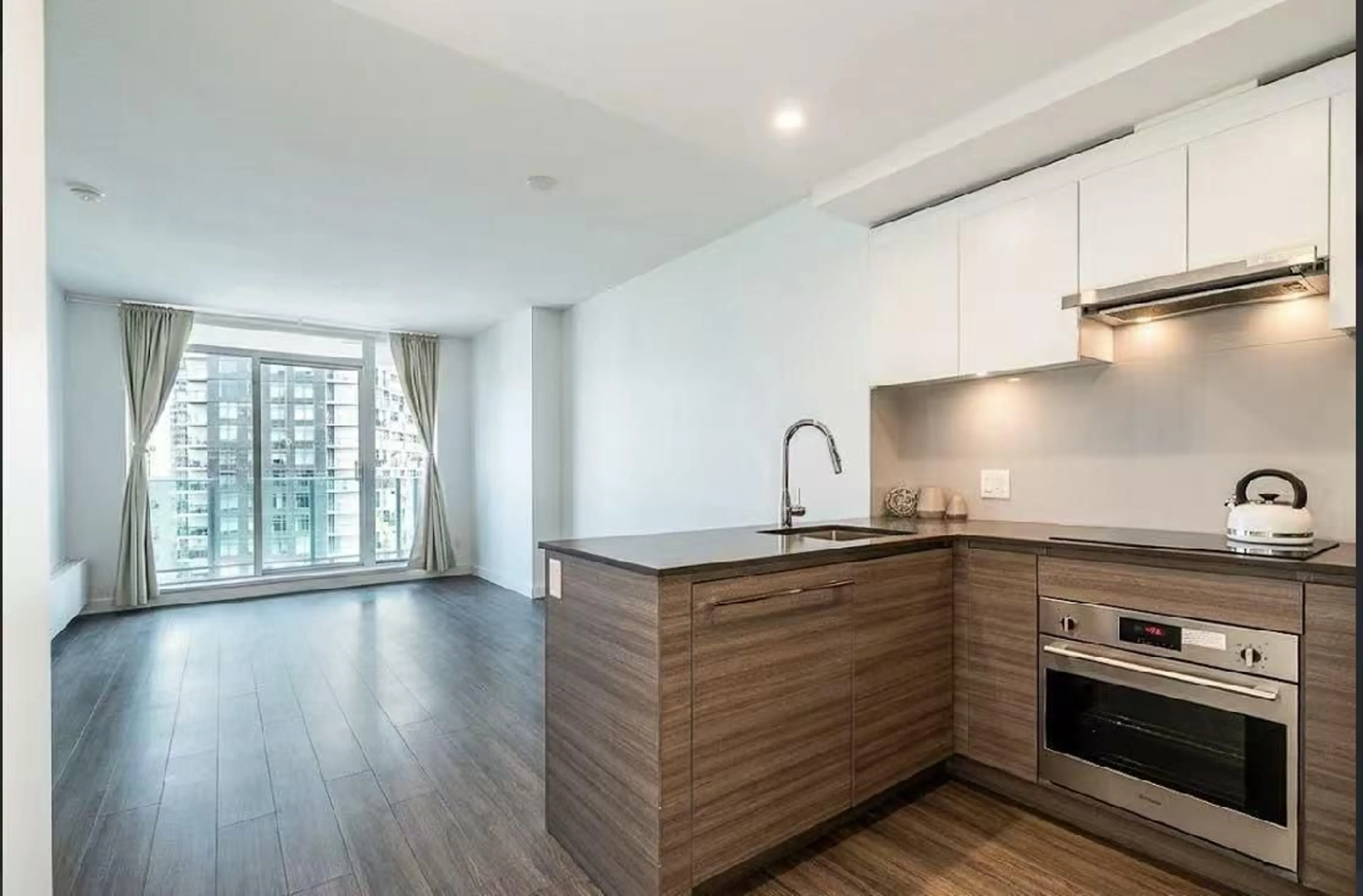Open concept kitchen, wood/laminate floor for 1905 - 13655 FRASER HIGHWAY, Surrey British Columbia V3T0P8