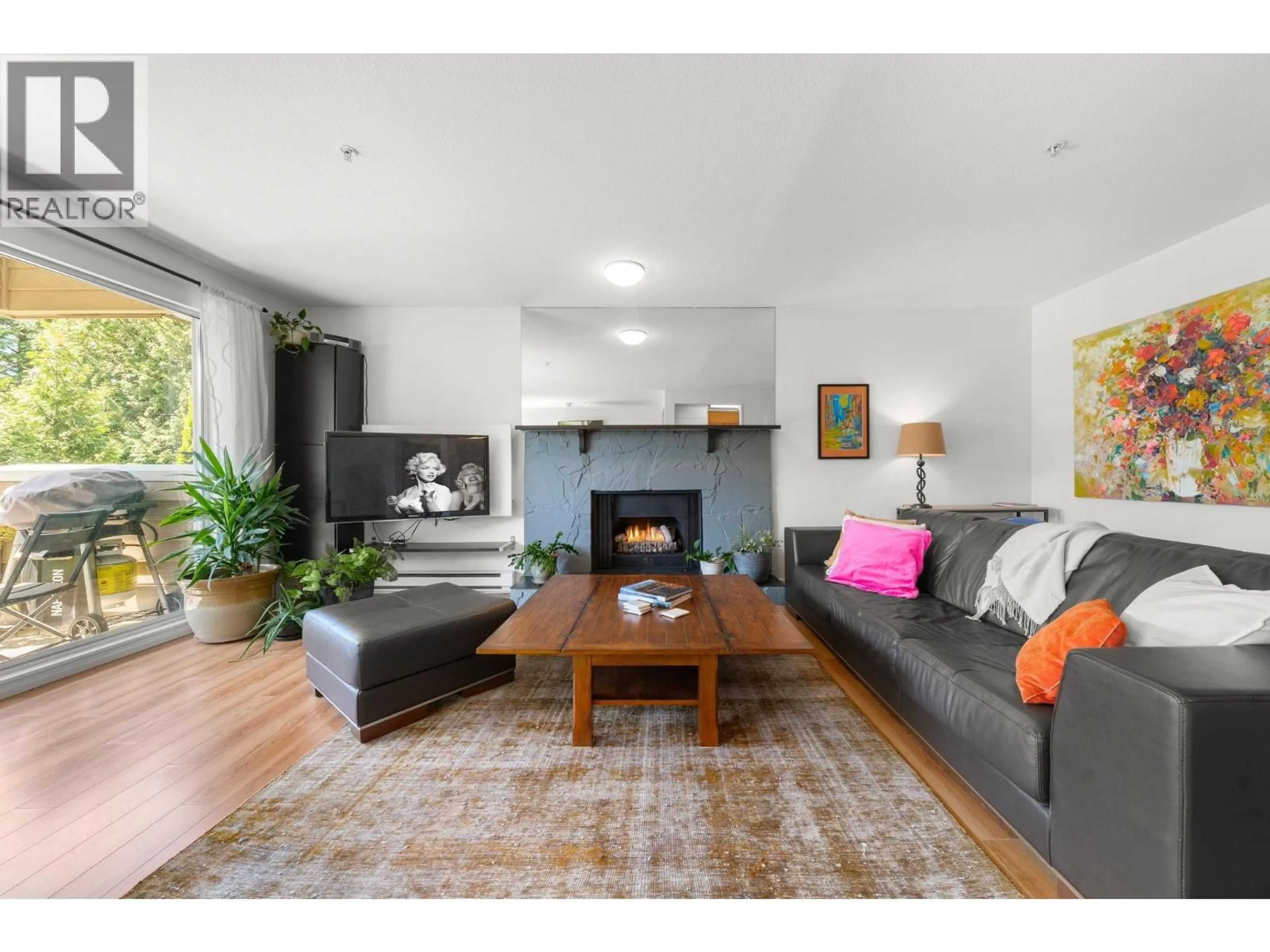Living room with furniture, wood/laminate floor for 202 - 1000 BOWRON COURT, North Vancouver British Columbia V7H2V7