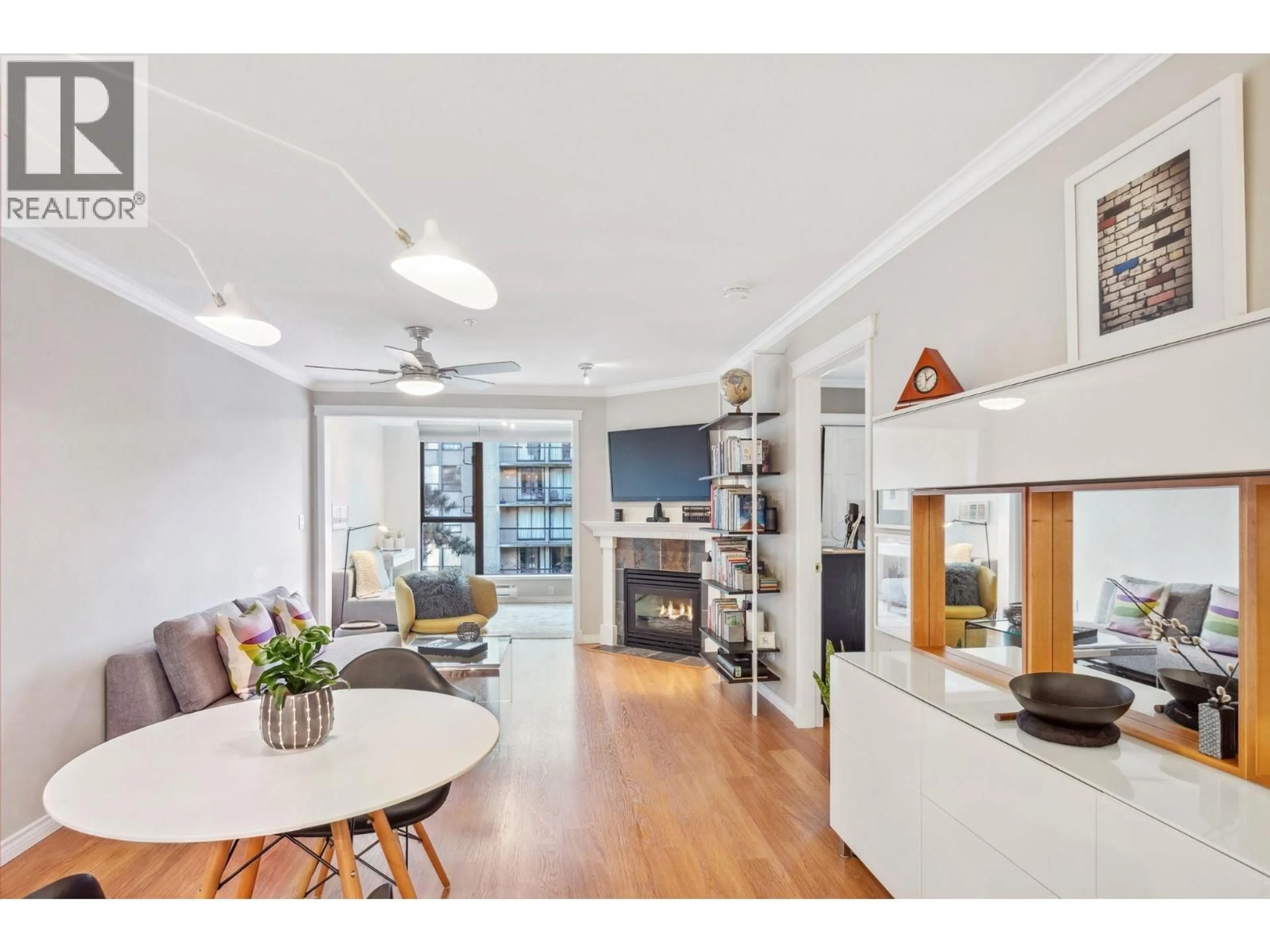 Living room with furniture, wood/laminate floor for 206 - 175 10TH STREET, North Vancouver British Columbia V7L4W1