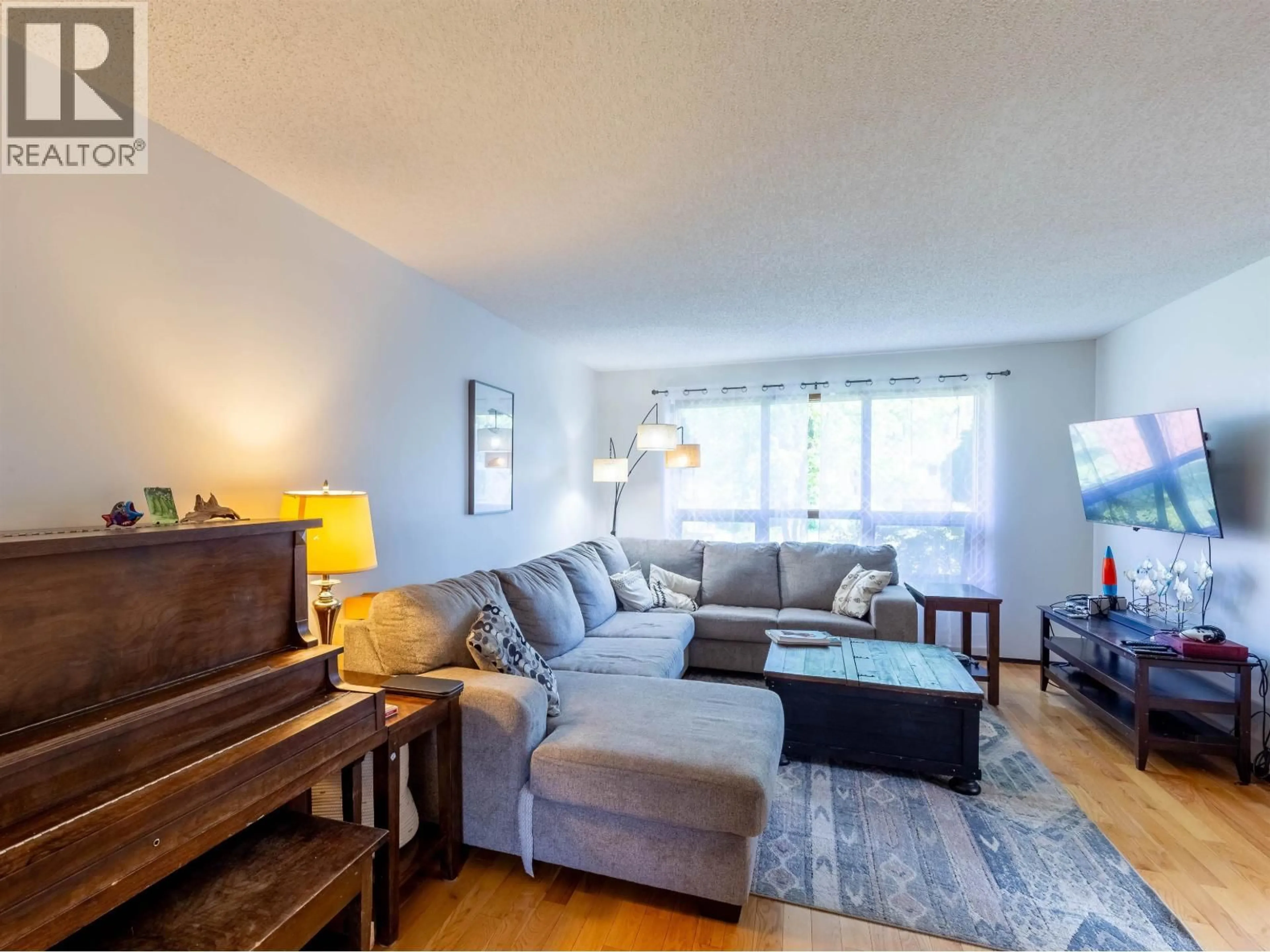 Living room with furniture, wood/laminate floor for 3454 NADINA PLACE, Smithers British Columbia V0J2N0