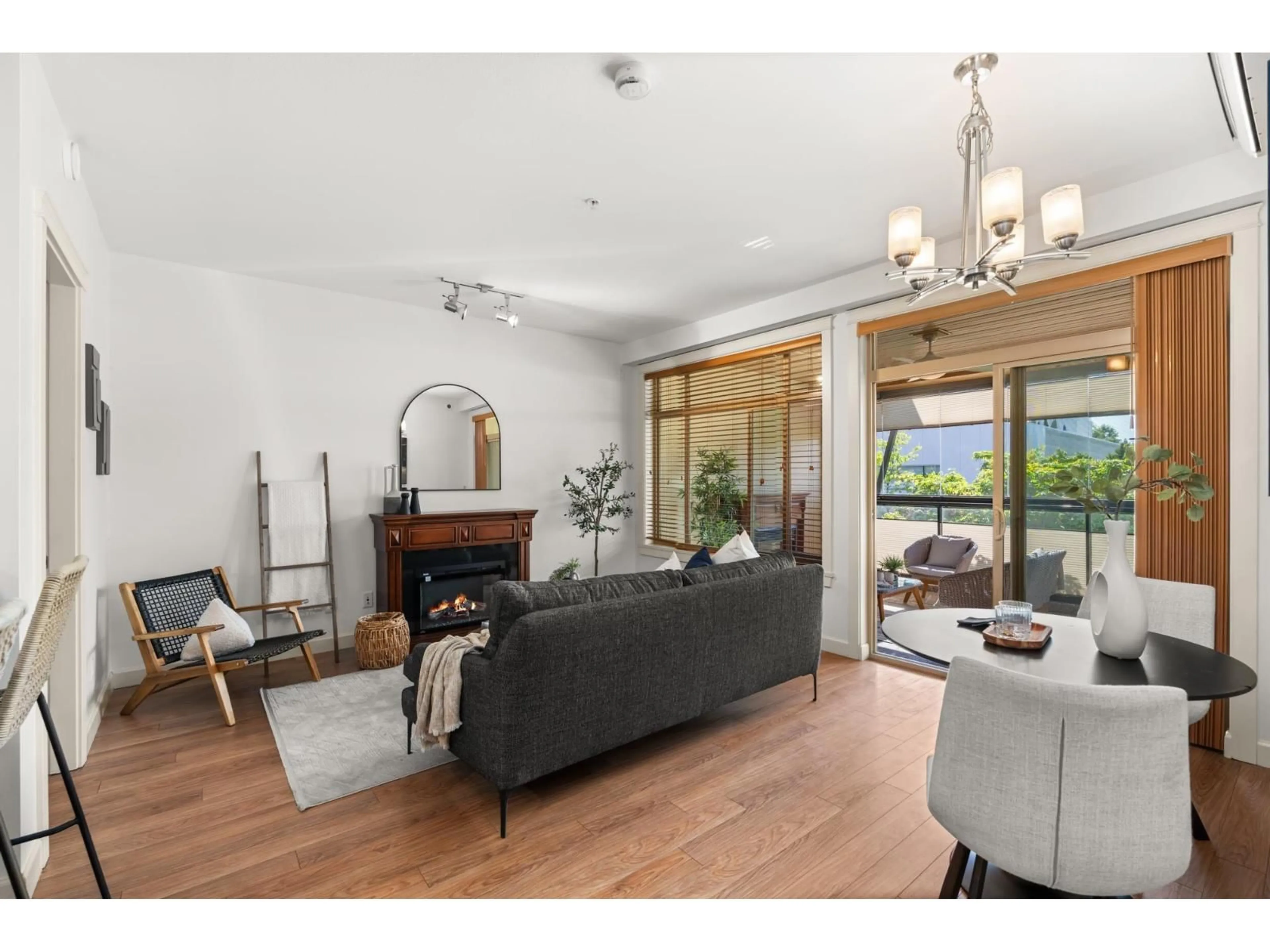Living room with furniture, wood/laminate floor for 202 - 2860 TRETHEWEY STREET, Abbotsford British Columbia V2T0G5
