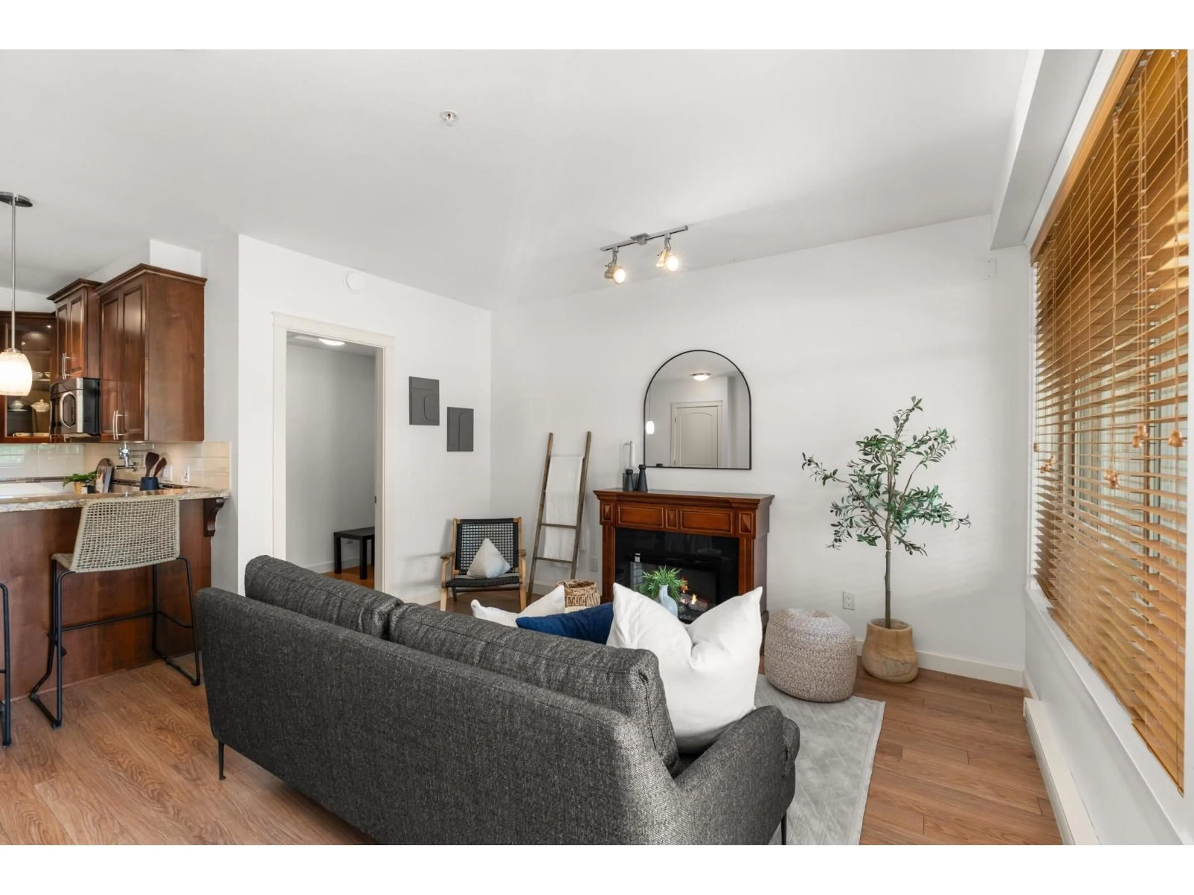 Living room with furniture, wood/laminate floor for 202 - 2860 TRETHEWEY STREET, Abbotsford British Columbia V2T0G5