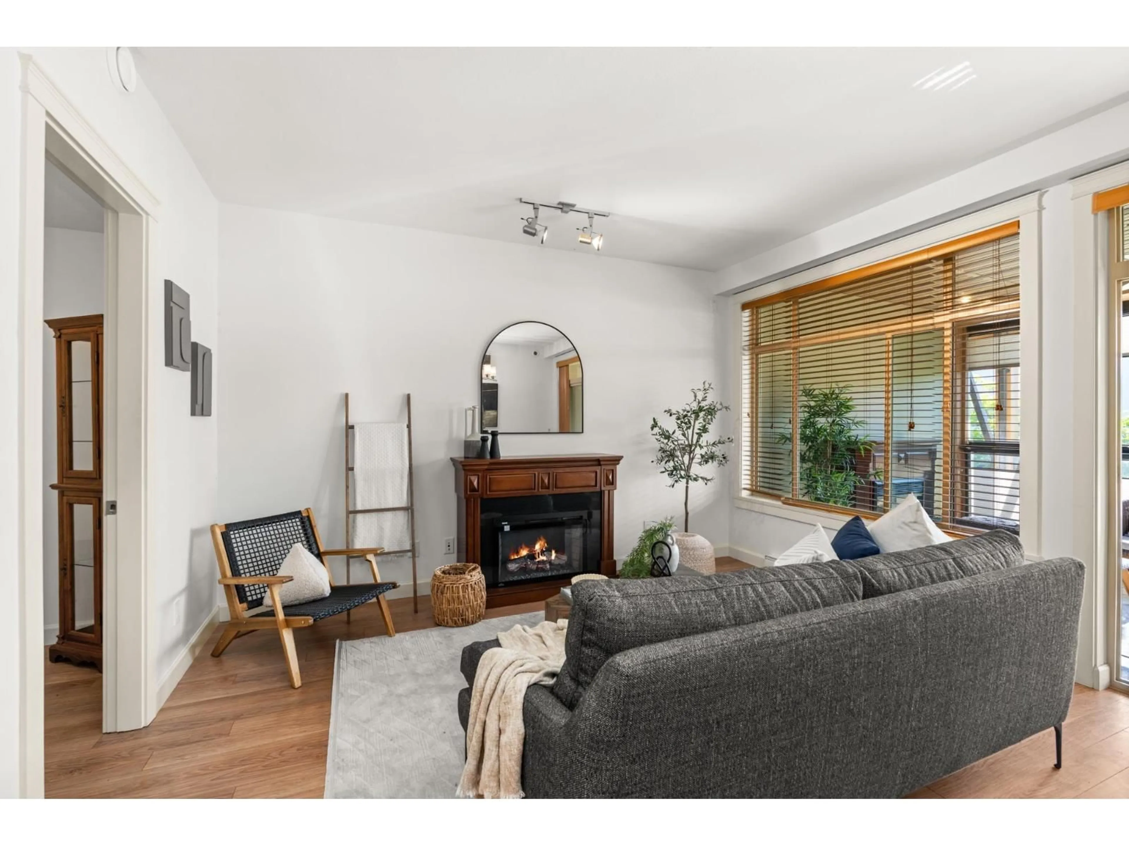 Living room with furniture, wood/laminate floor for 202 - 2860 TRETHEWEY STREET, Abbotsford British Columbia V2T0G5