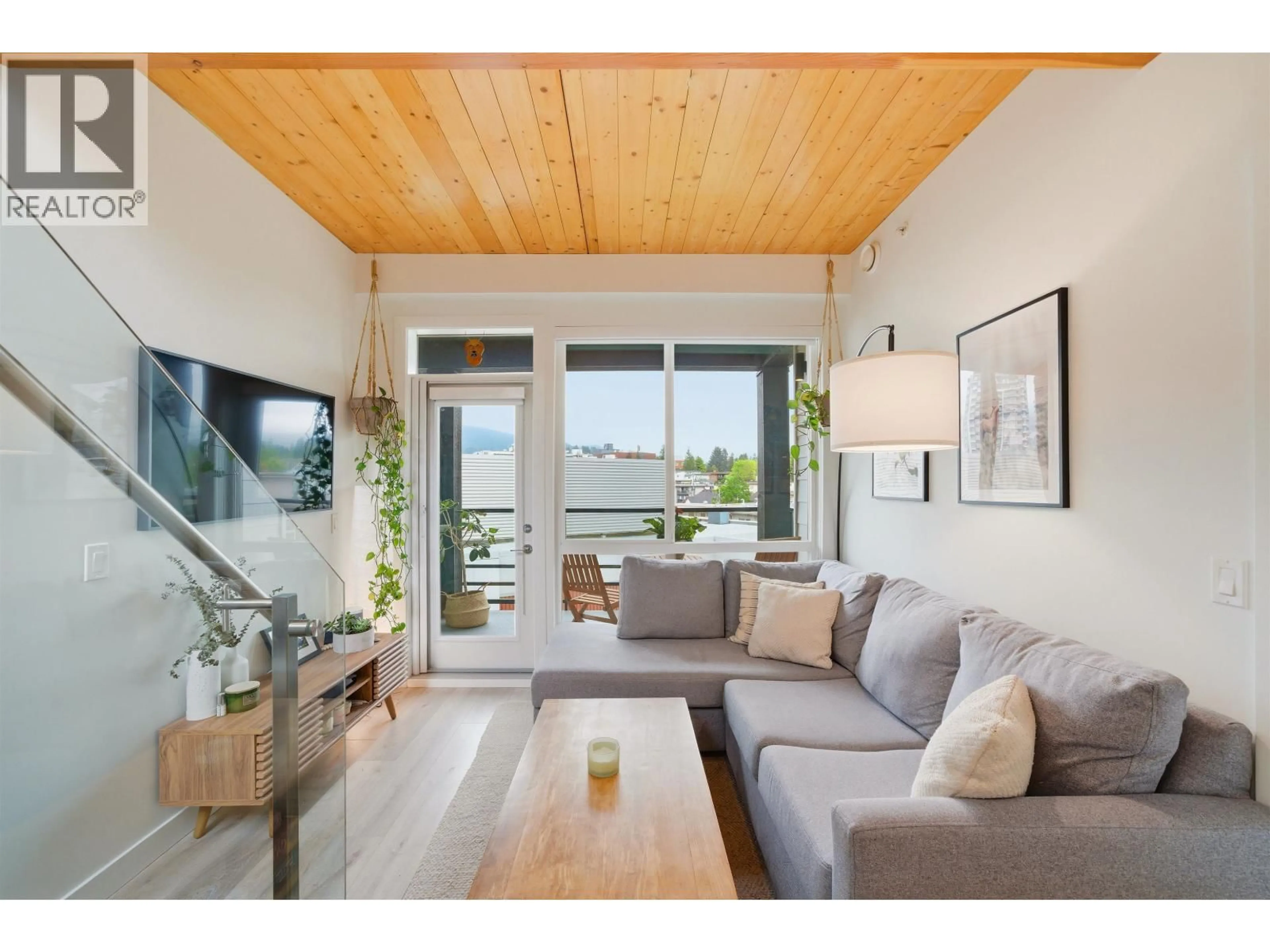 Living room with furniture, wood/laminate floor for 607 - 128 8TH STREET, North Vancouver British Columbia V7L0H2