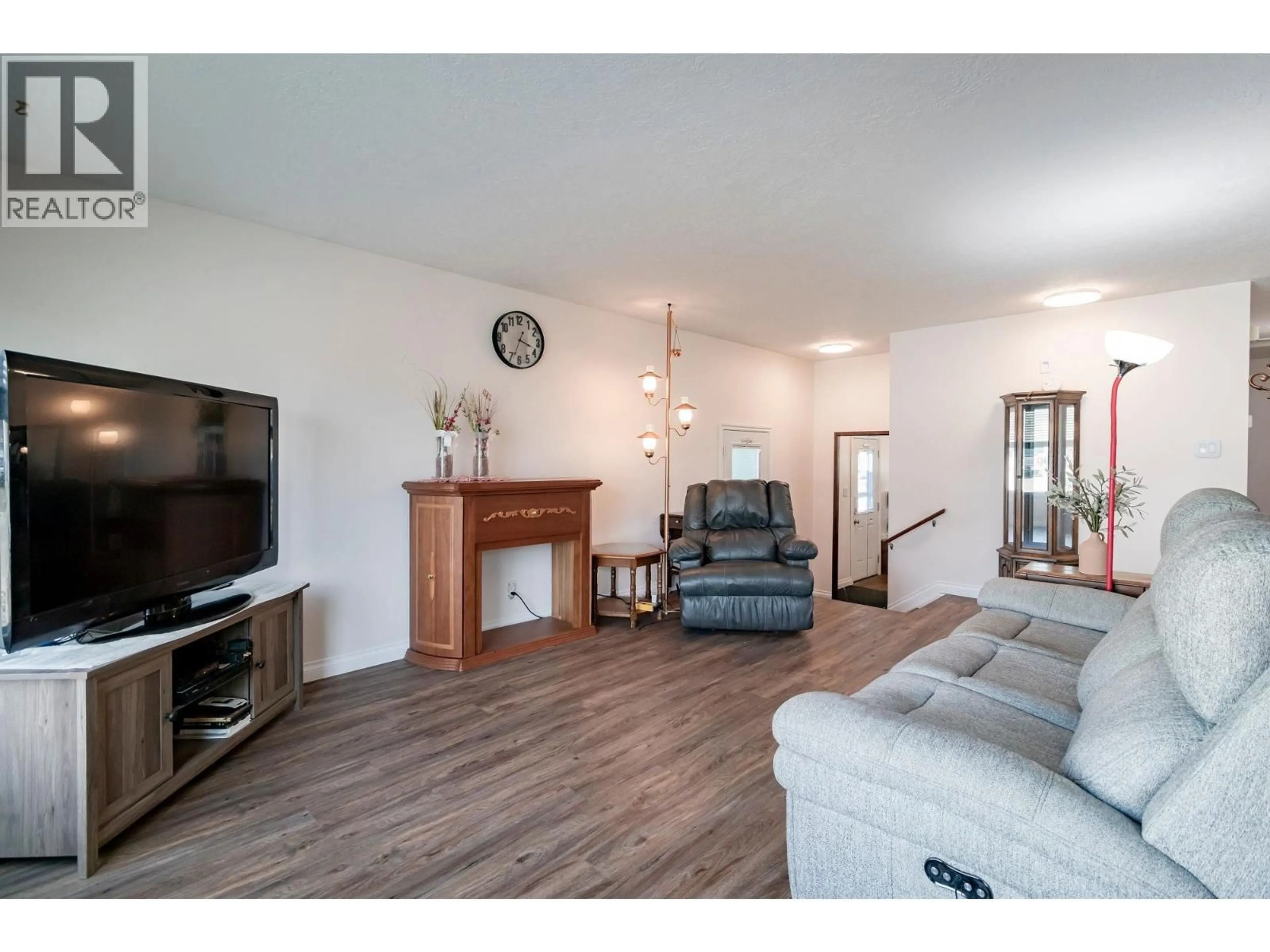 Living room with furniture, wood/laminate floor for 10311 103 AVENUE, Fort St. John British Columbia V1J2H7