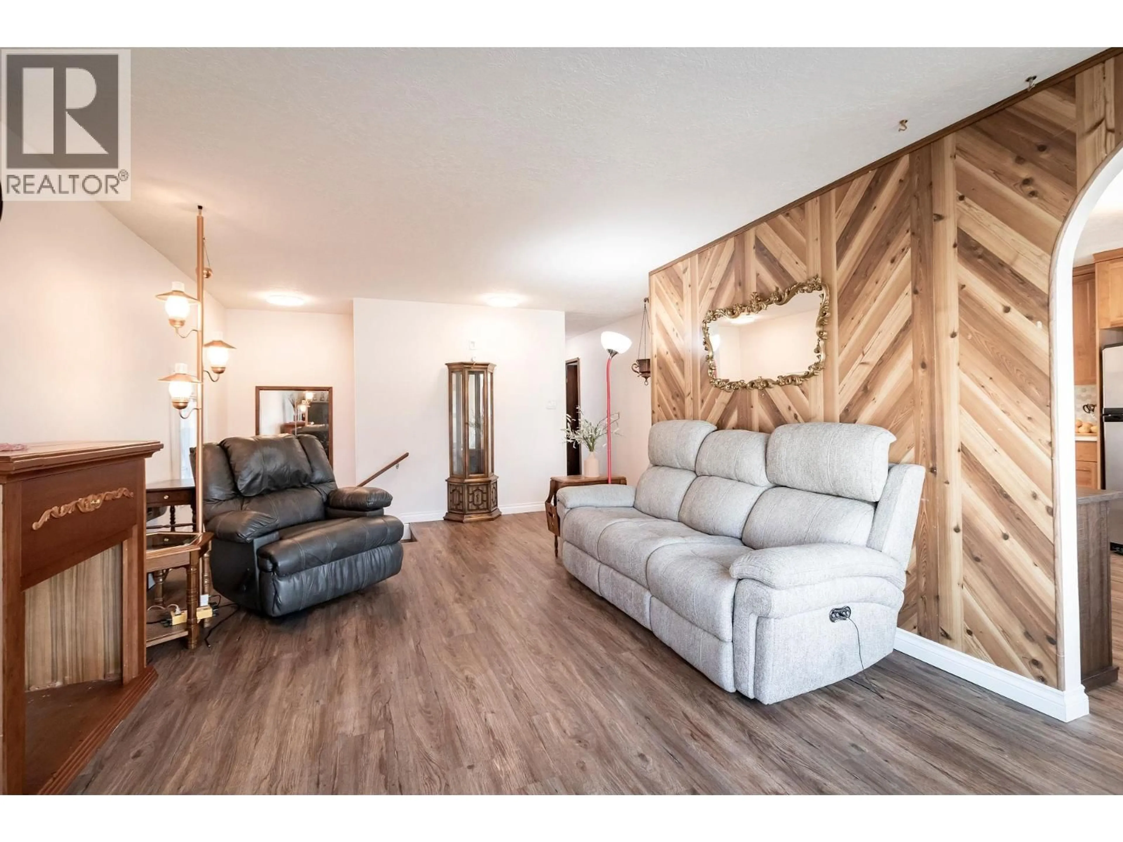 Living room with furniture, wood/laminate floor for 10311 103 AVENUE, Fort St. John British Columbia V1J2H7