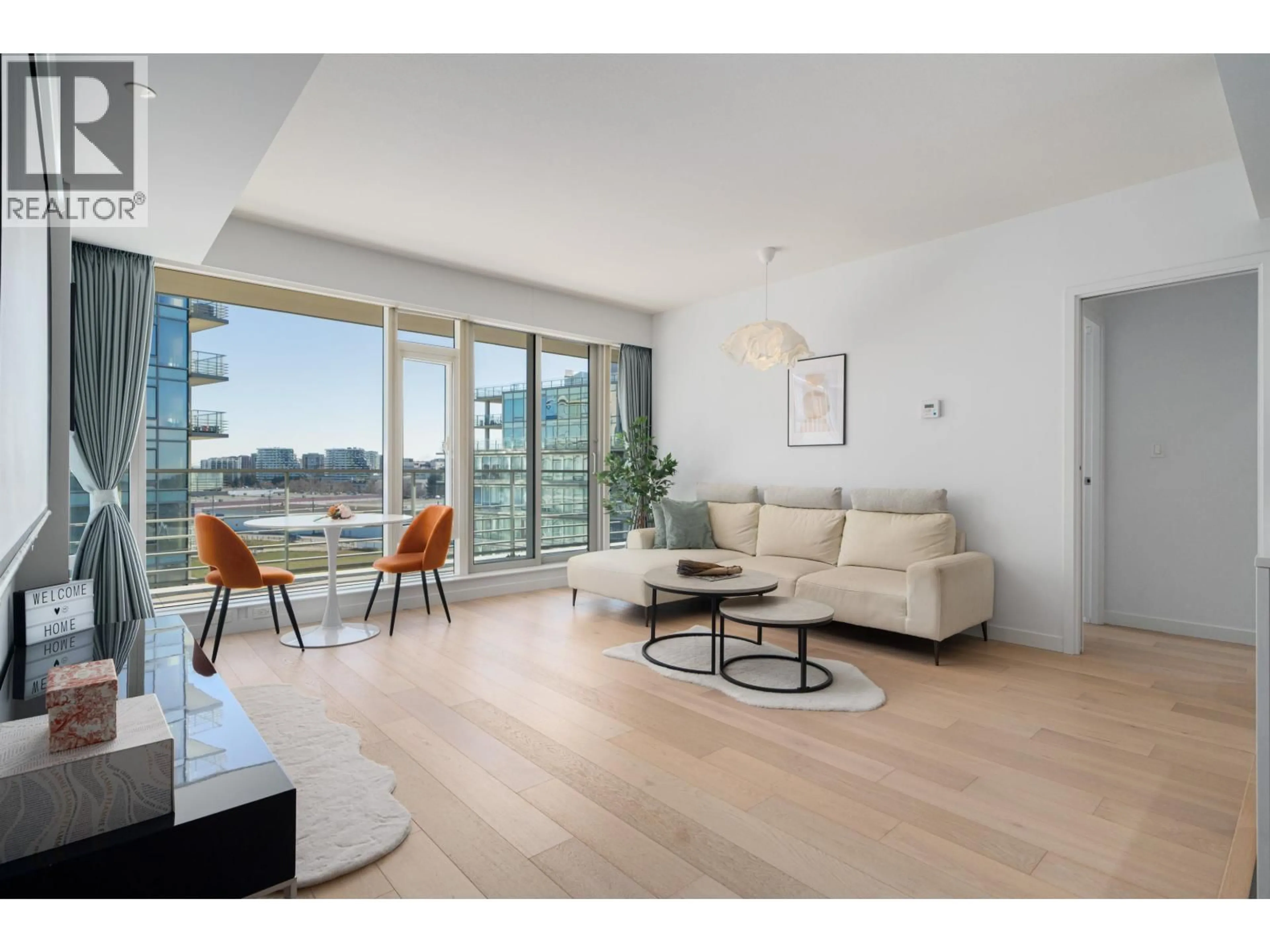 Living room with furniture, wood/laminate floor for 703 - 5171 BRIGHOUSE WAY, Richmond British Columbia V7C0A6