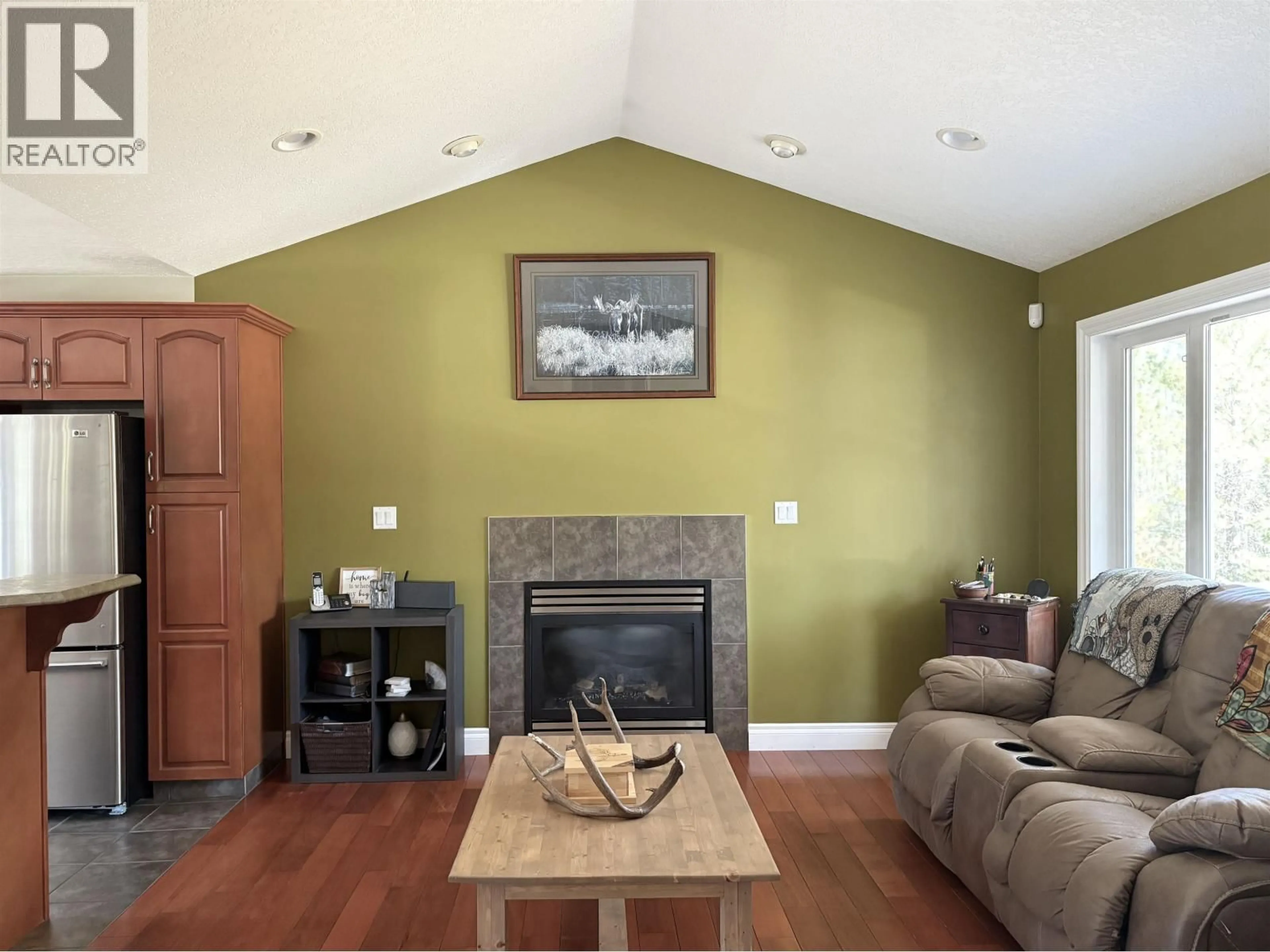 Living room with furniture, wood/laminate floor for 9133 SYKES ROAD, Prince George British Columbia V2N6N4