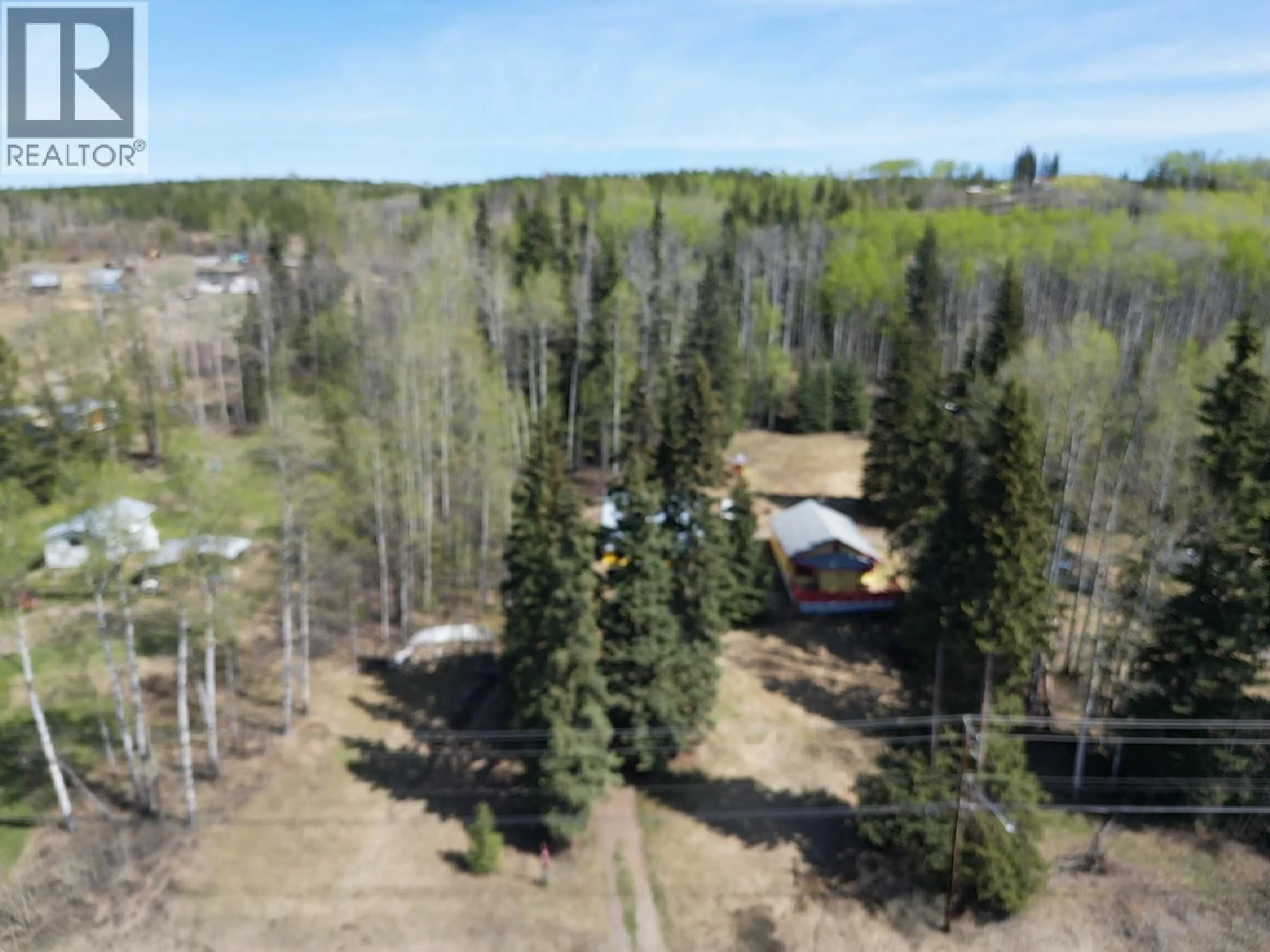 A pic from outside/outdoor area/front of a property/back of a property/a pic from drone, forest/trees view for 10258 W 16 HIGHWAY, Burns Lake British Columbia V0J1E1