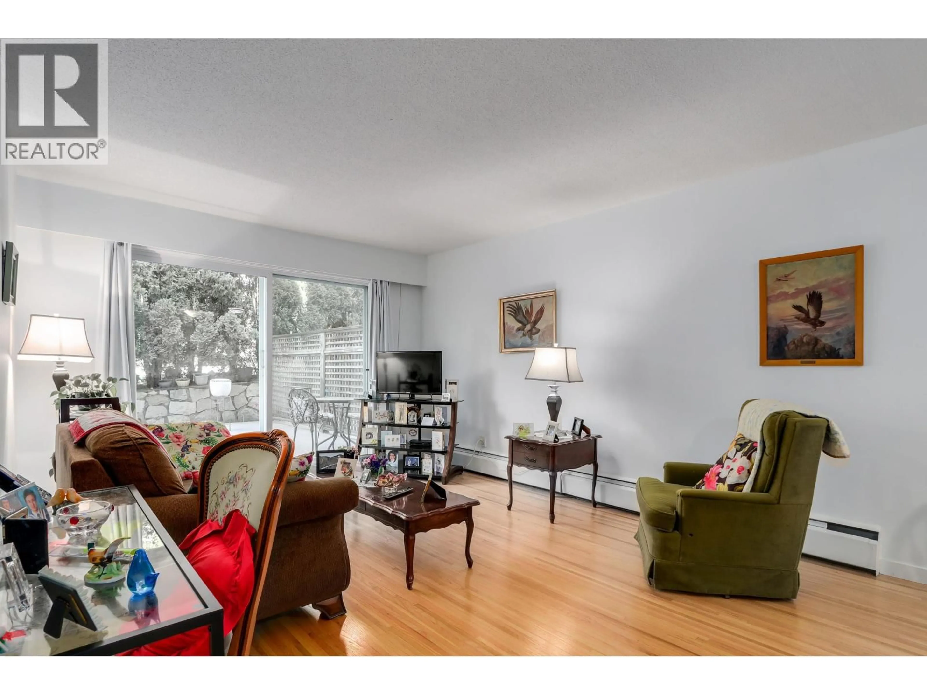 Living room with furniture, wood/laminate floor for 104 - 135 21ST STREET, North Vancouver British Columbia V7M1Z2