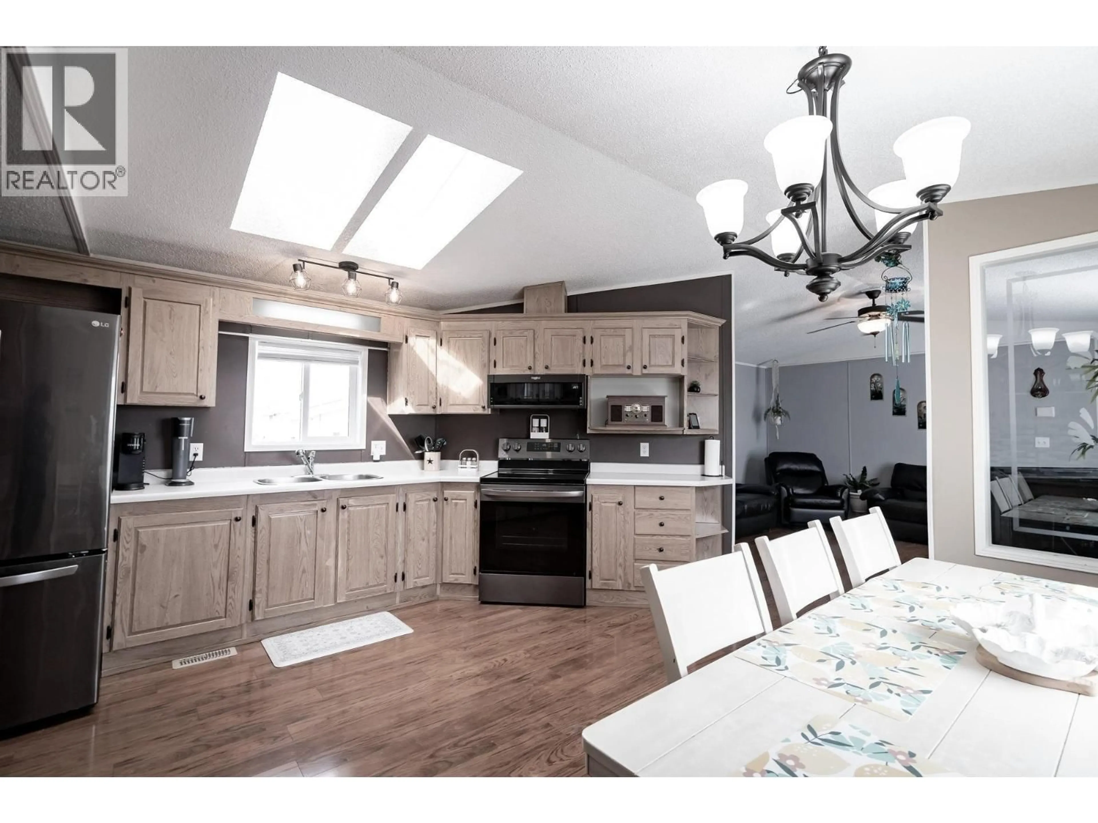 Open concept kitchen, wood/laminate floor for 7947 269 ROAD, Fort St. John British Columbia V1J1H0