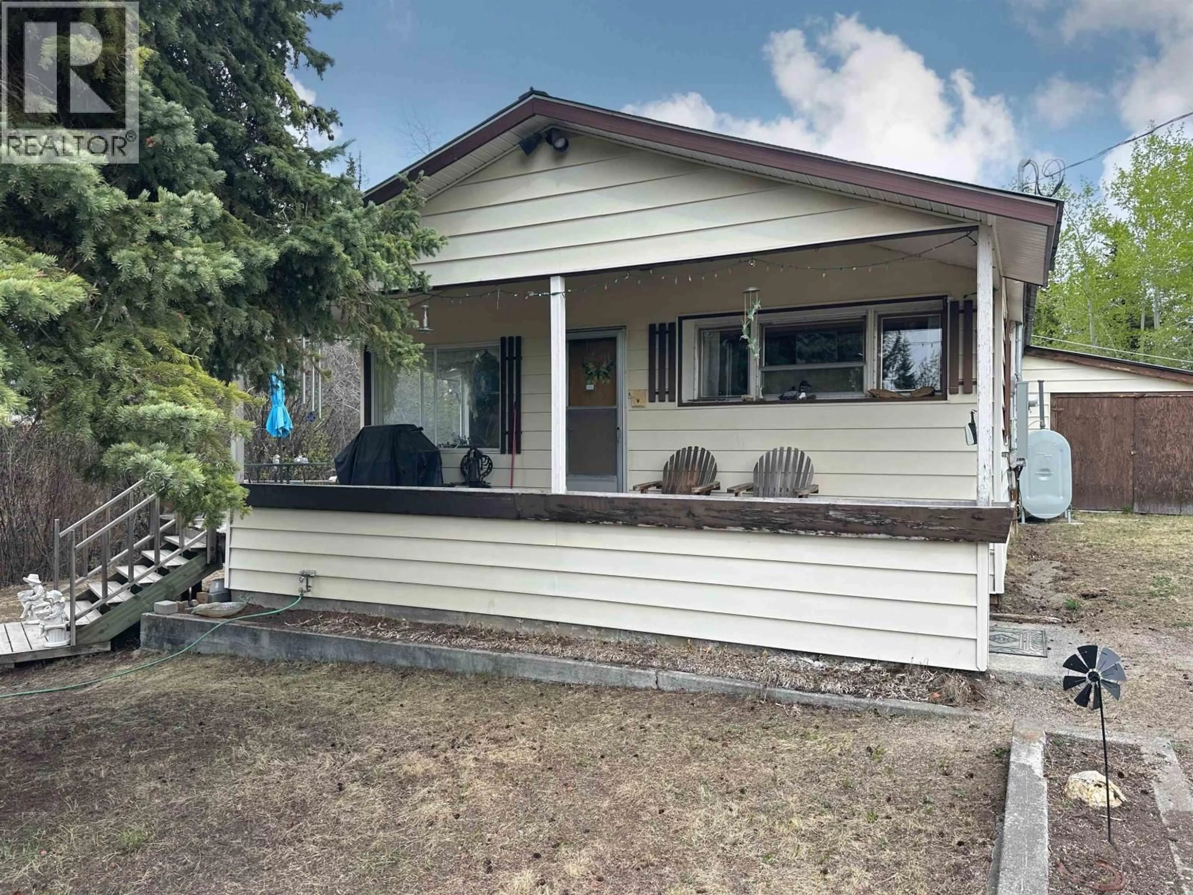 Home with vinyl exterior material, street for 6808 STOKES ROAD, 100 Mile House British Columbia V0K2E2