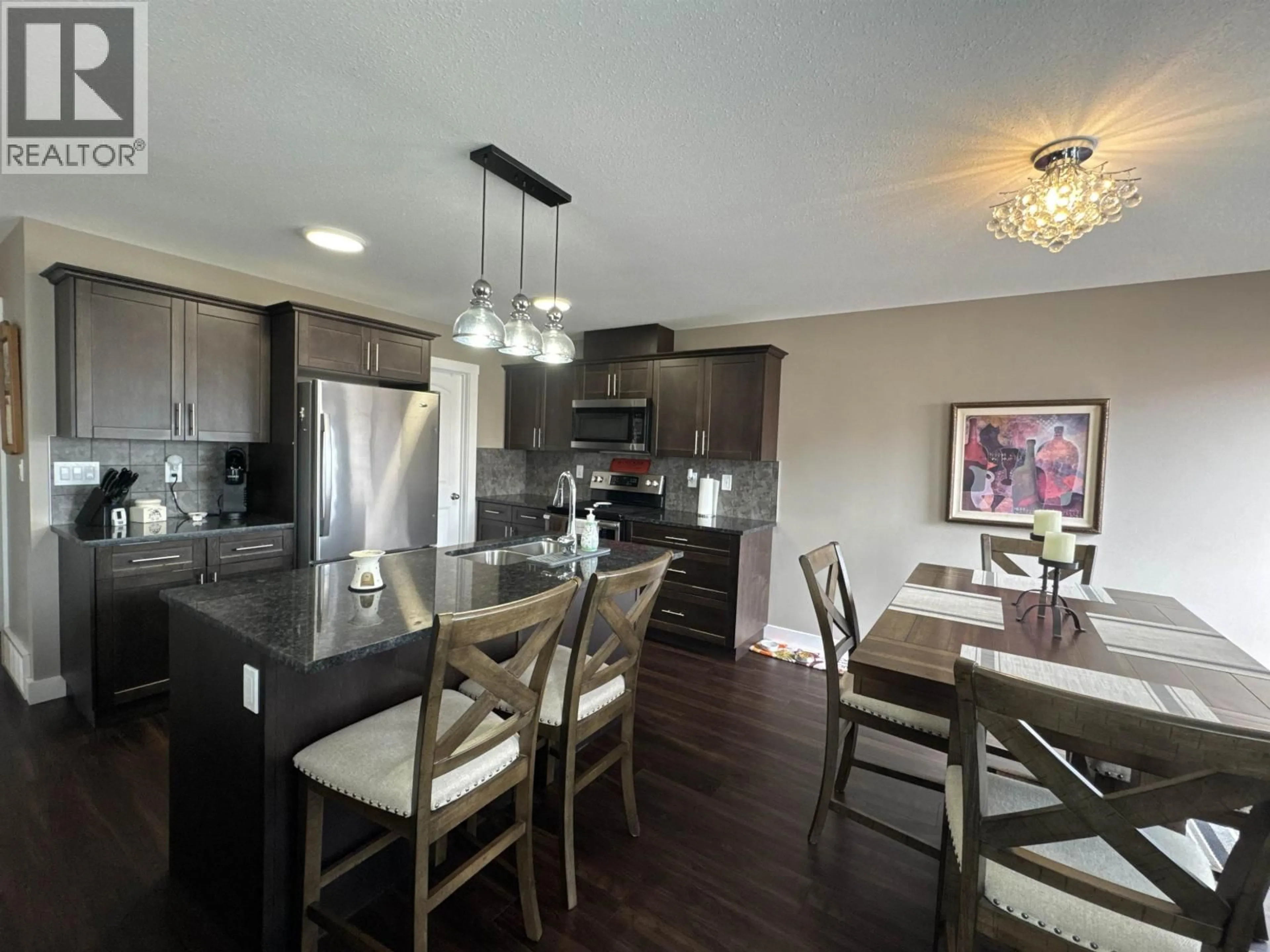 Open concept kitchen, wood/laminate floor for 109 - 10104 114A AVENUE, Fort St. John British Columbia V1J0K5