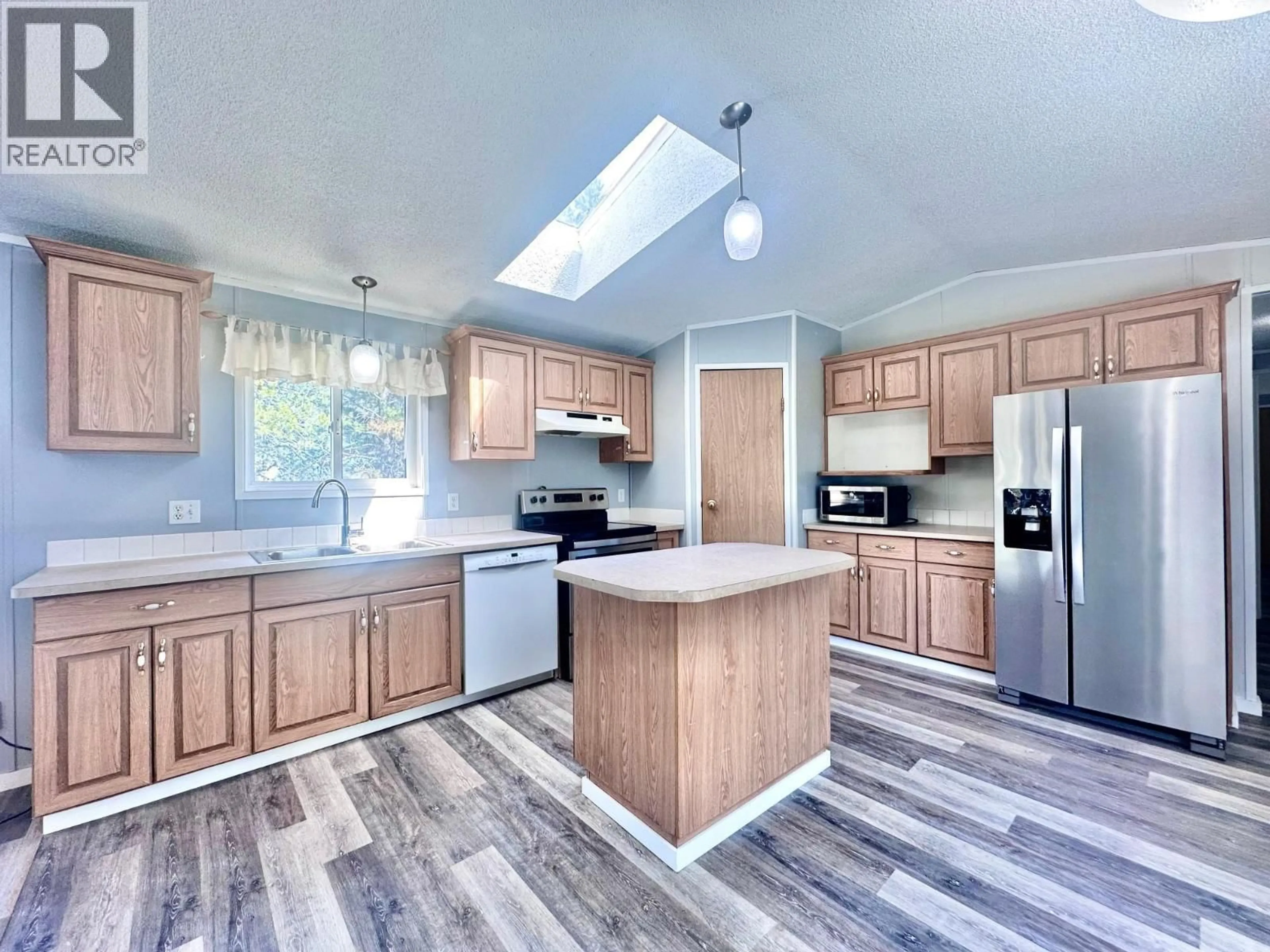 Open concept kitchen, wood/laminate floor for 845 BEAVEN CRESCENT, Valemount British Columbia V0E2Z0