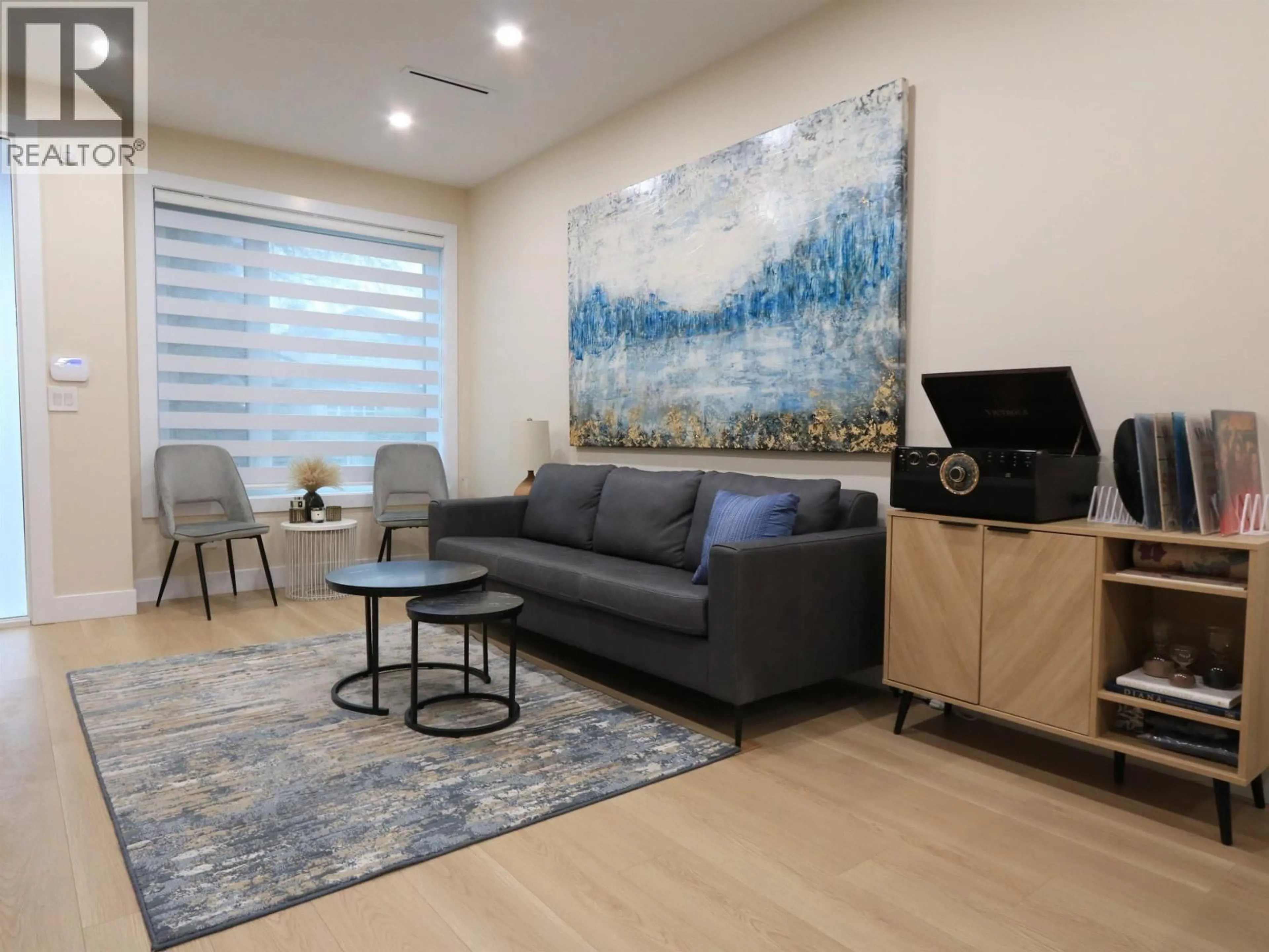 Living room with furniture, wood/laminate floor for 2828 CHEYENNE AVENUE, Vancouver British Columbia V5R4R6