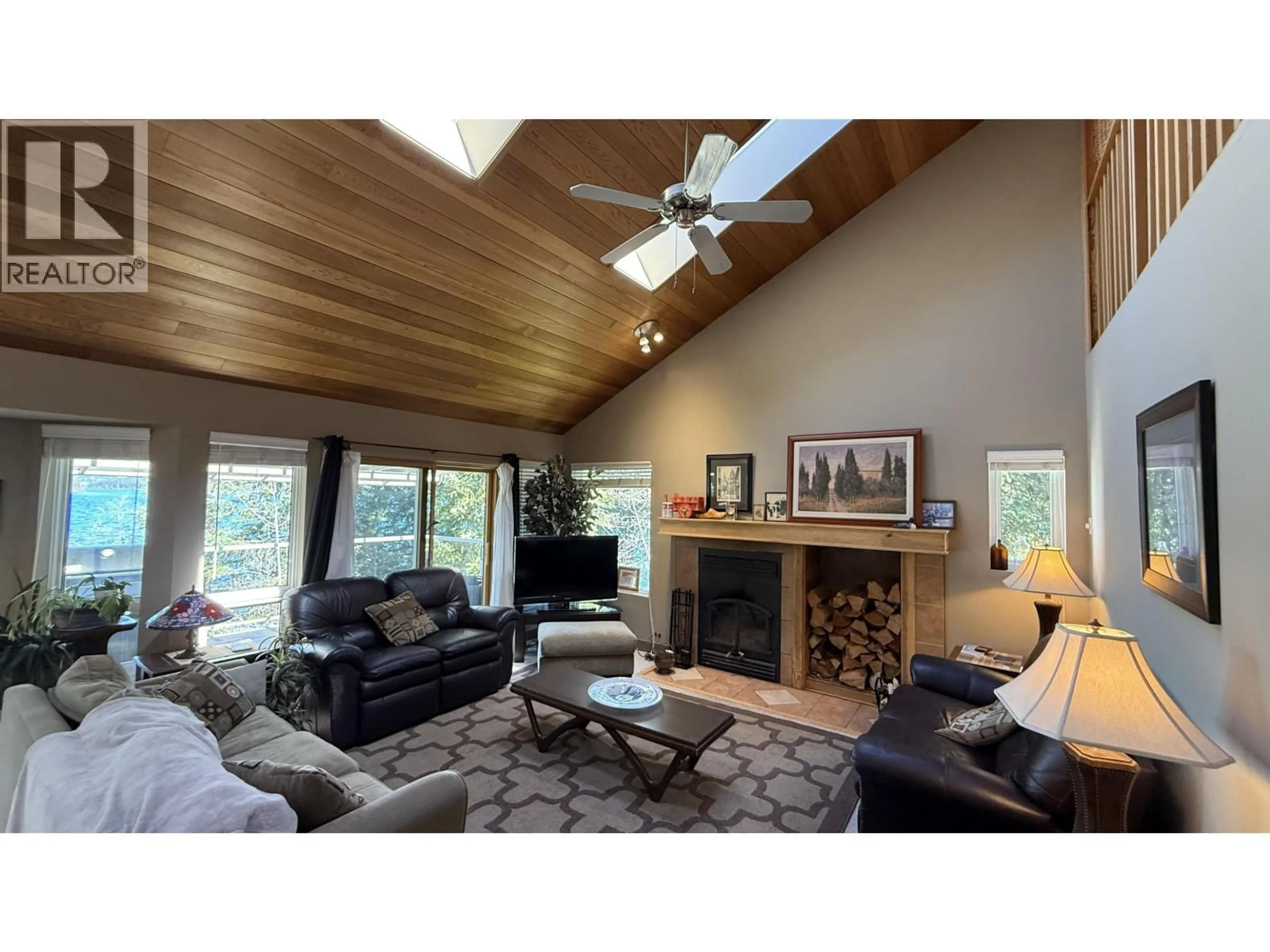 Living room with furniture, wood/laminate floor for 8187 COTTONWOOD BAY ROAD, Bridge Lake British Columbia V0K1X2