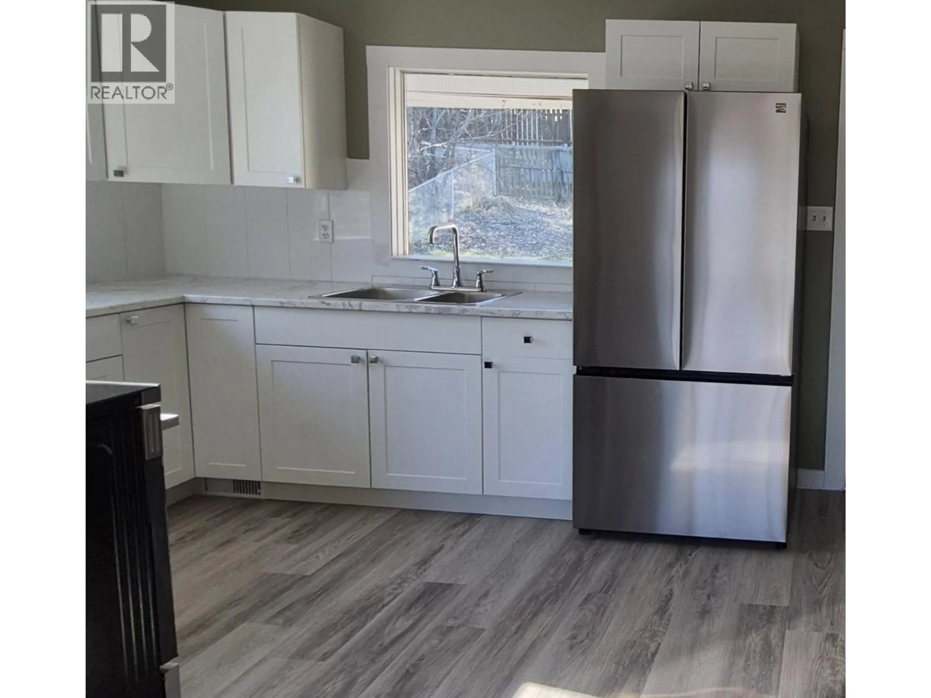 Open concept kitchen, wood/laminate floor for 324 5TH STREET, Vanderhoof British Columbia V0J3A0