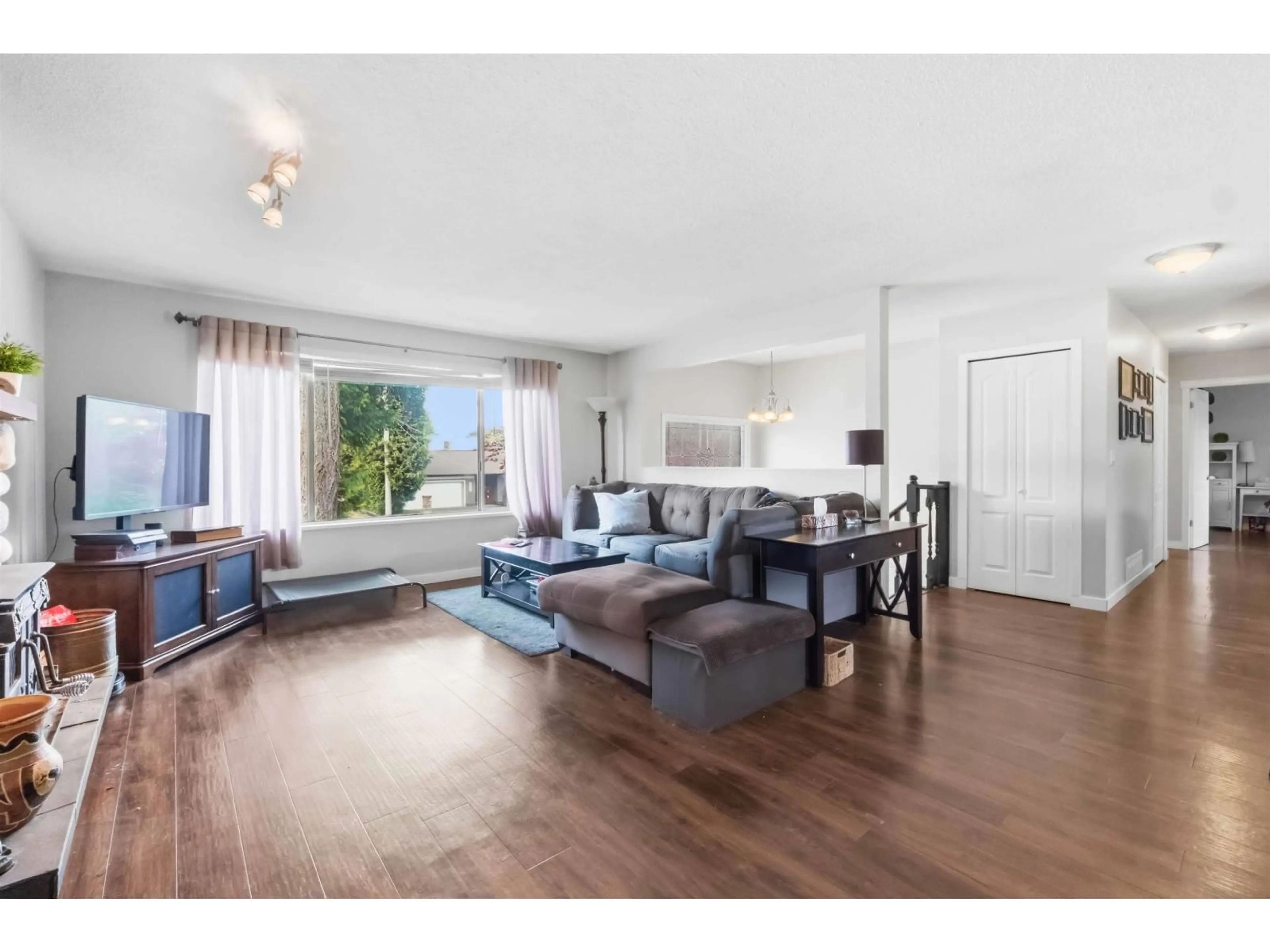 Living room with furniture, wood/laminate floor for 4618 207A STREET, Langley British Columbia V3A5N3