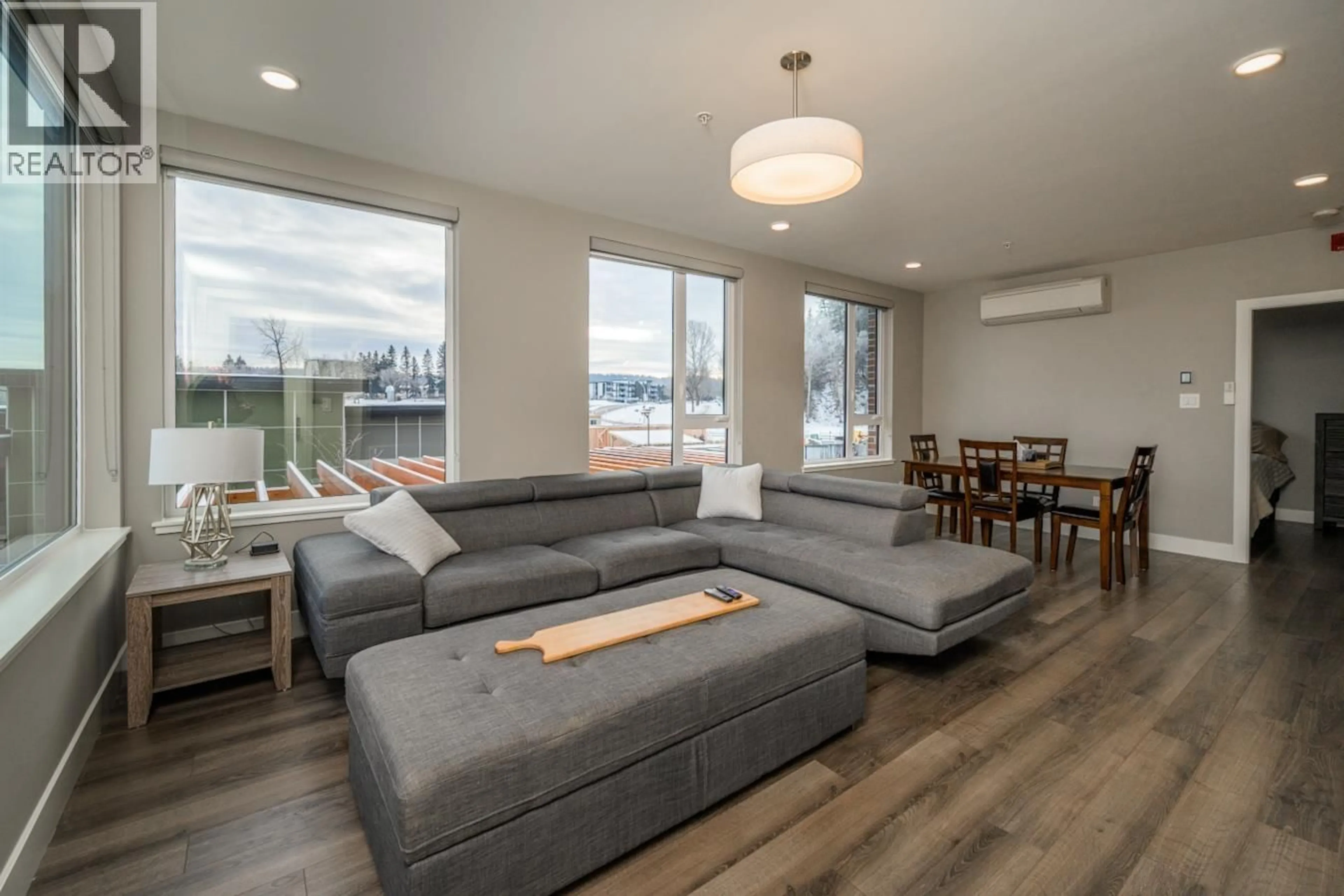 Living room with furniture, wood/laminate floor for 201 - 1087 6TH AVENUE, Prince George British Columbia V2L0E5