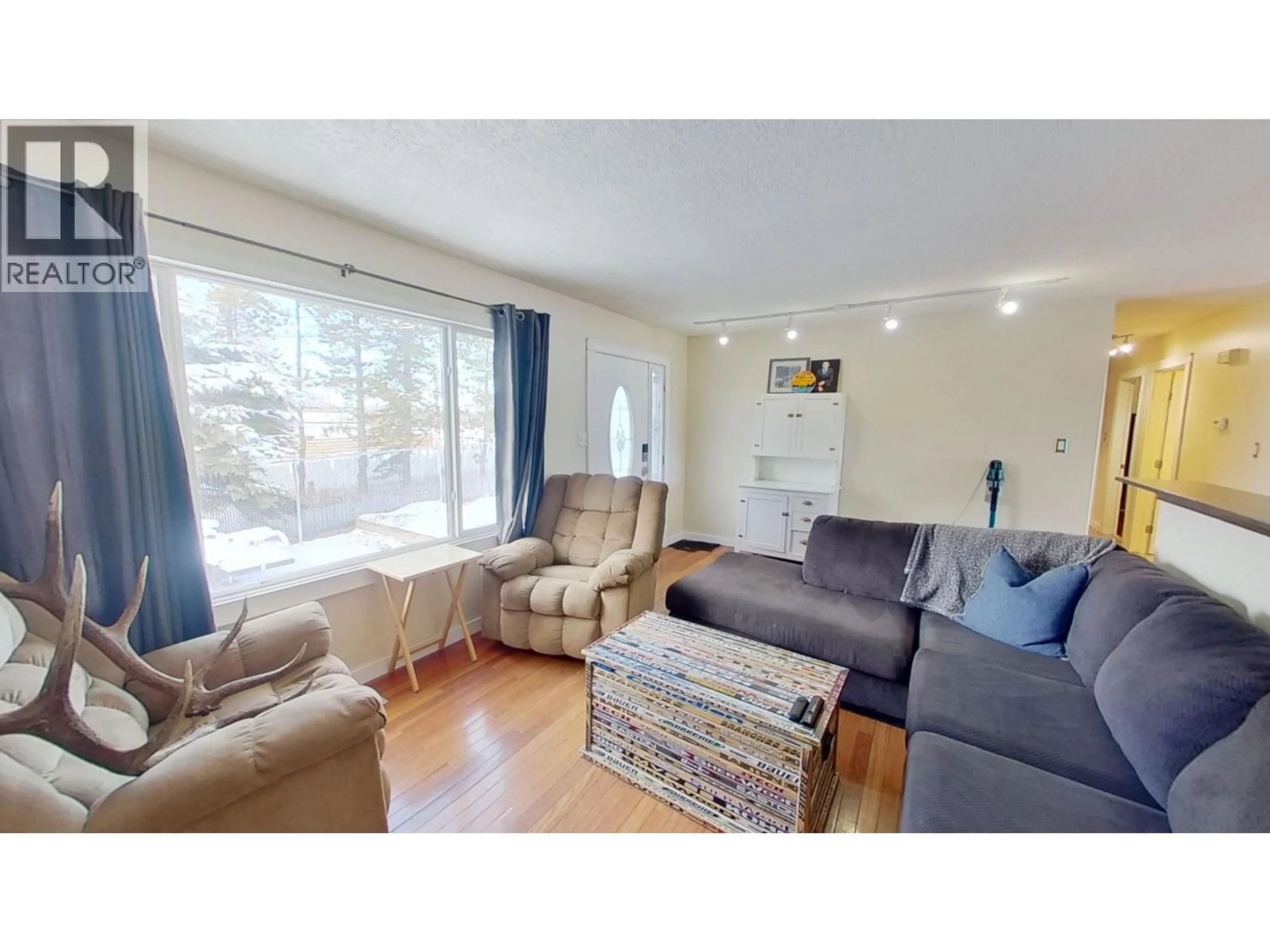 Living room with furniture, wood/laminate floor for 8824 PINE ROAD, Fort St. John British Columbia V1J4M7