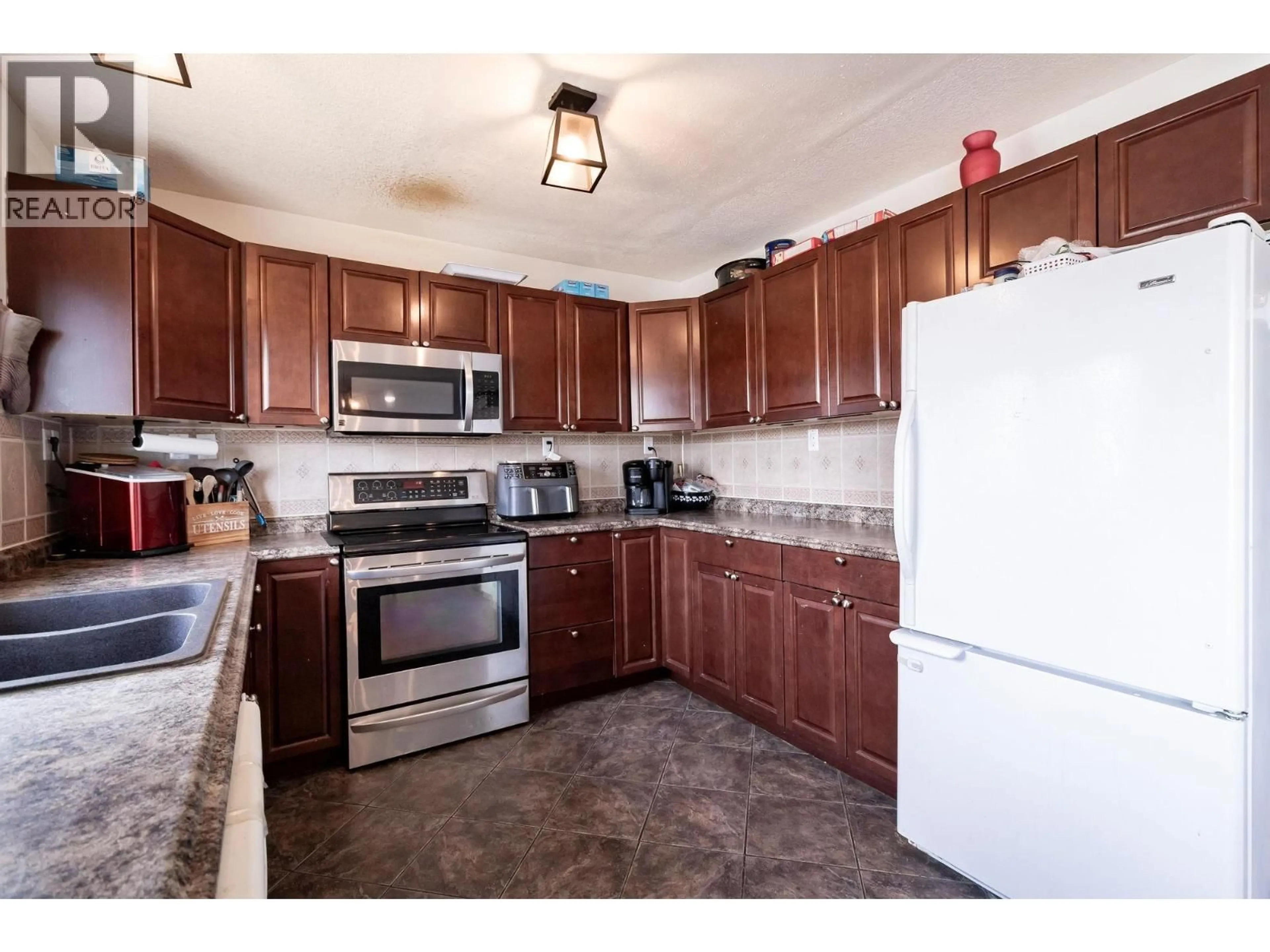 Standard kitchen, ceramic/tile floor for 9016 77 STREET, Fort St. John British Columbia V1J3A6