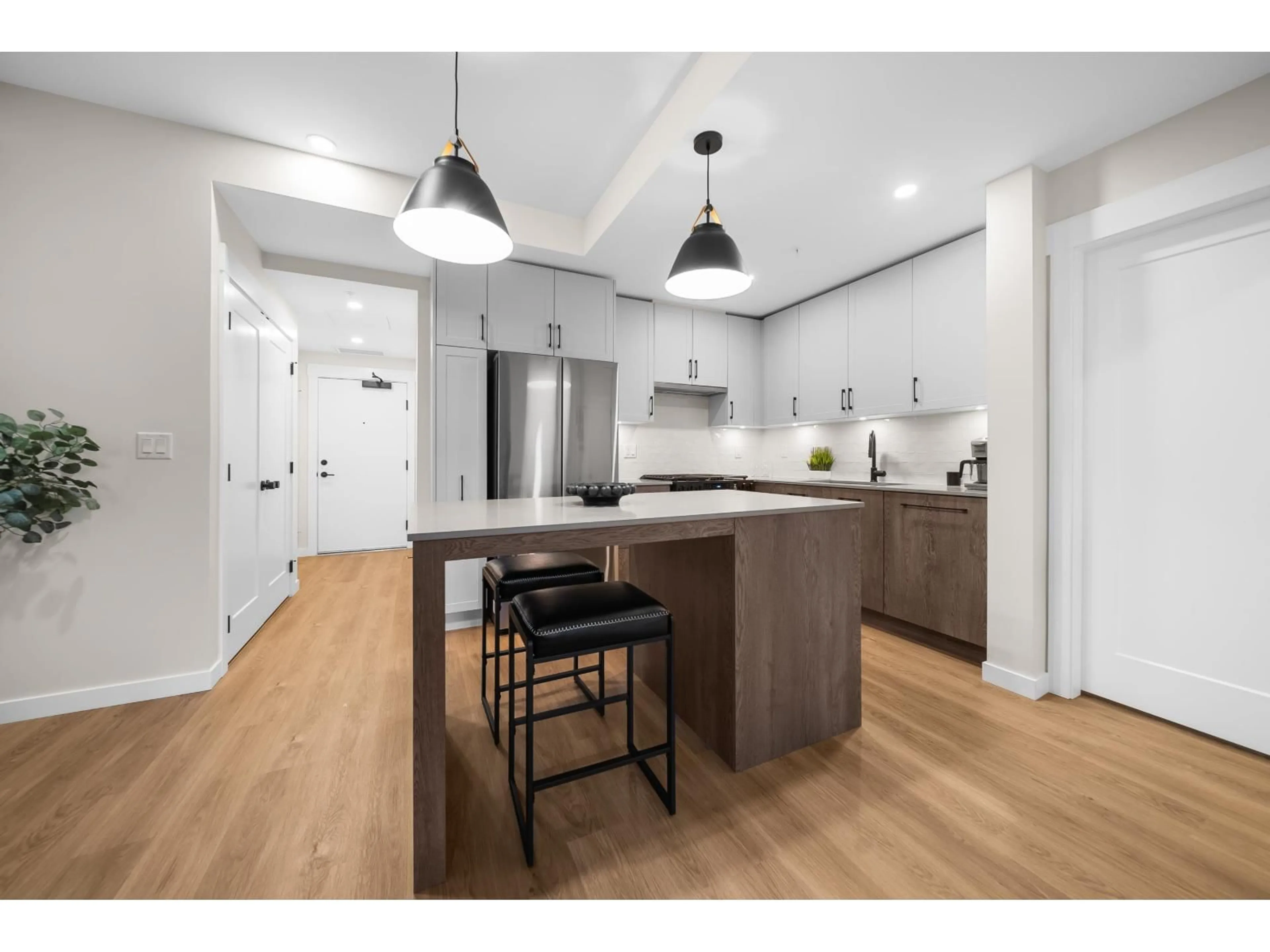 Open concept kitchen, wood/laminate floor for 201 - 27218 ALDERGROVE TOWN CENTRE DRIVE, Langley British Columbia V4W0E2