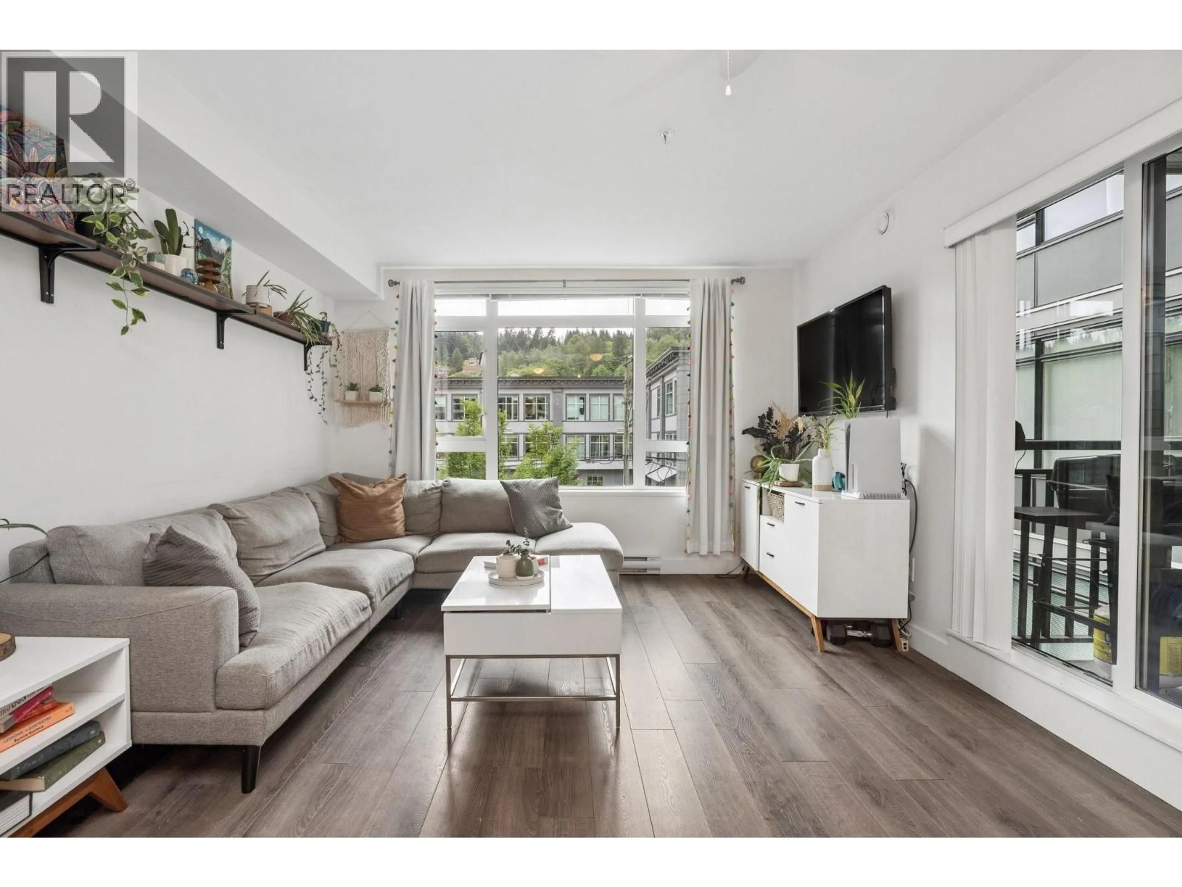 Living room with furniture, wood/laminate floor for 302 - 2525 CLARKE STREET, Port Moody British Columbia V3H0J3