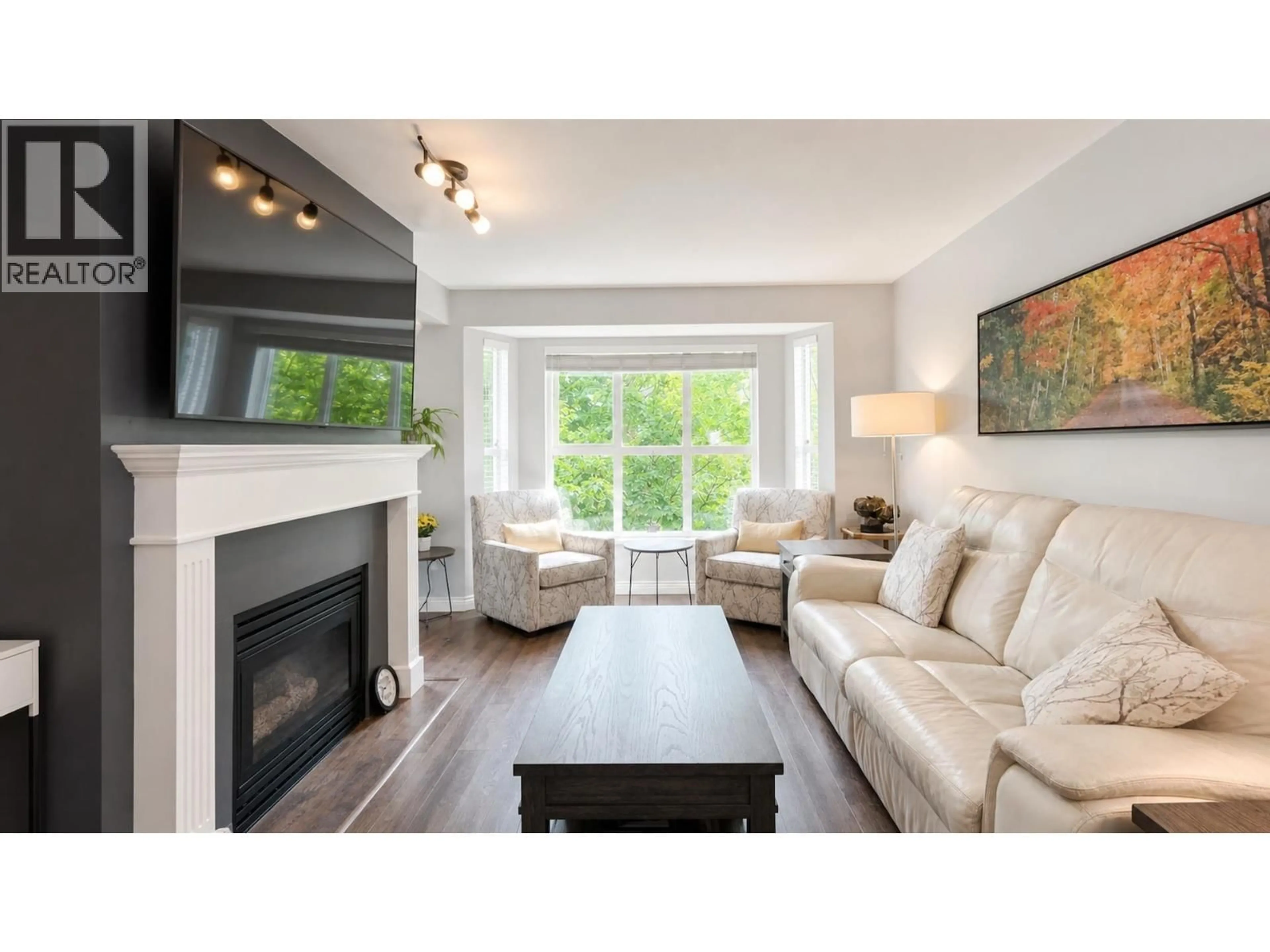 Living room with furniture, wood/laminate floor for 306 - 2393 WELCHER AVE AVENUE, Port Coquitlam British Columbia V3C1X6