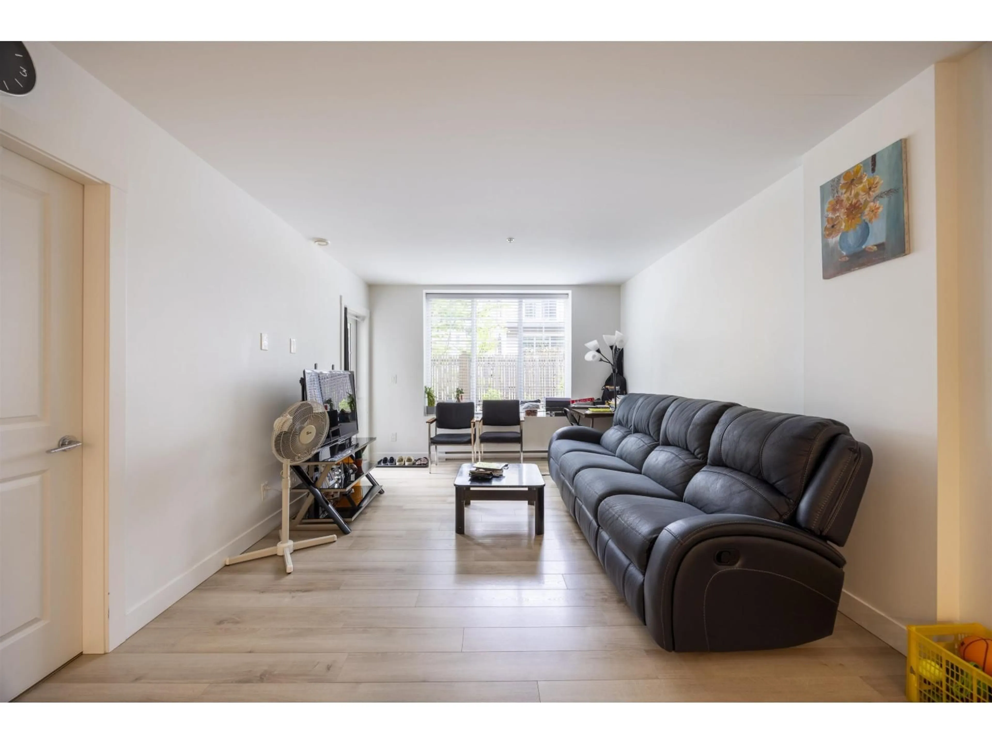Living room with furniture, wood/laminate floor for A104 - 20487 65 AVENUE, Langley British Columbia V2Y3K5