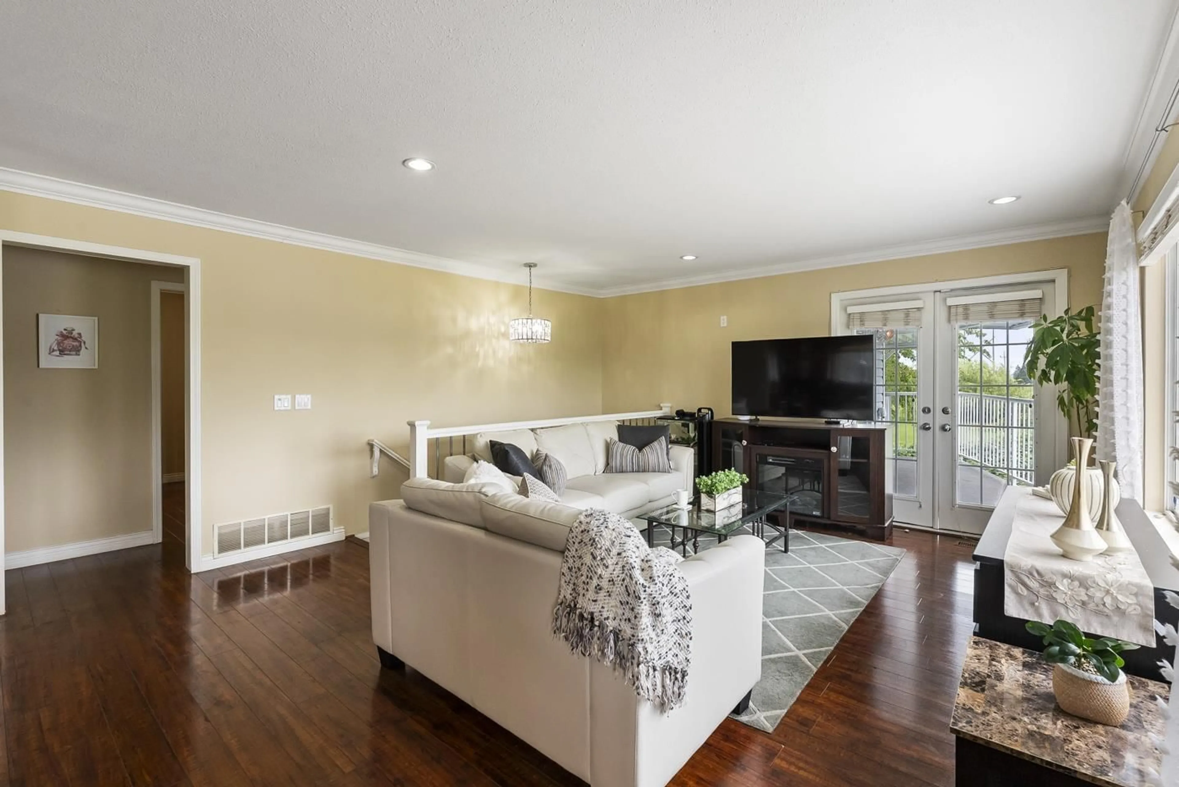 Living room with furniture, wood/laminate floor for 12649 89 AVENUE, Surrey British Columbia V3V1A5