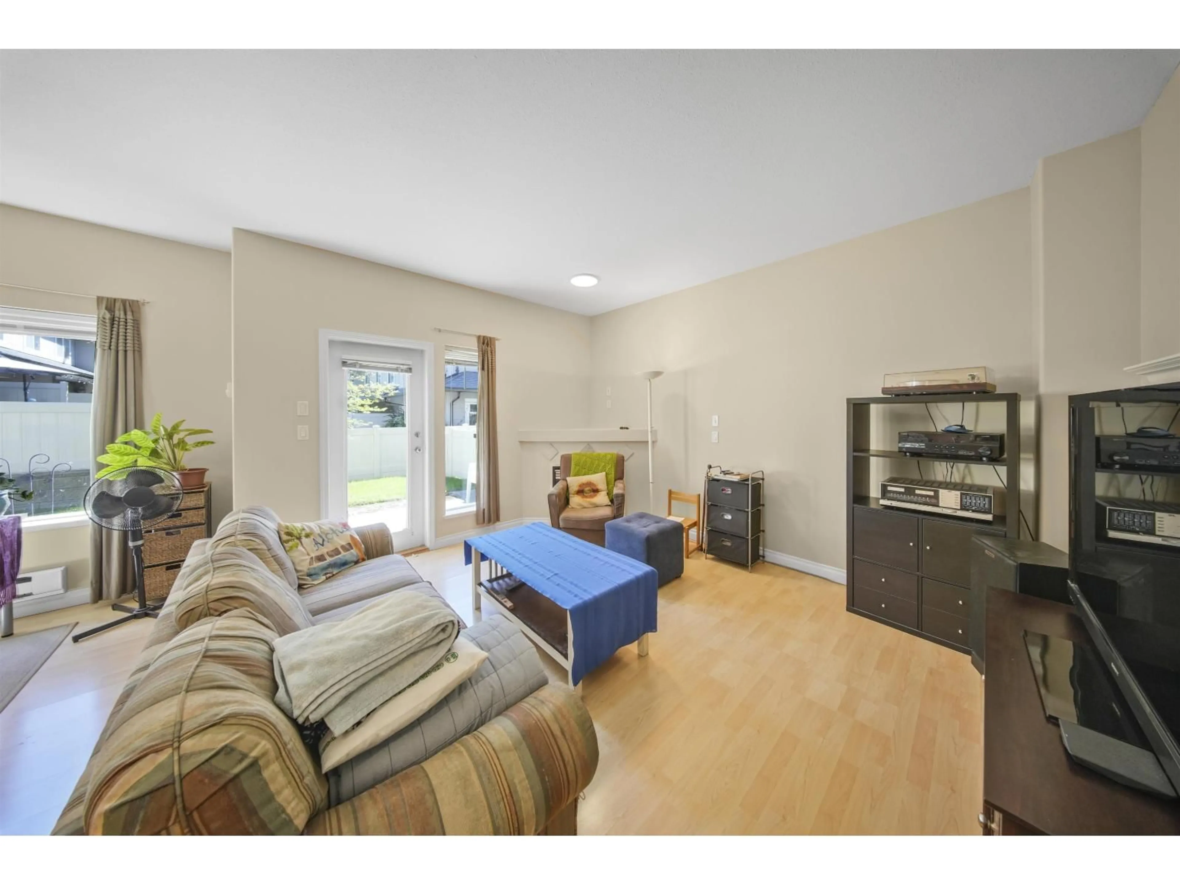 Living room with furniture, wood/laminate floor for 34 - 18181 68 AVENUE, Surrey British Columbia V3S9J1