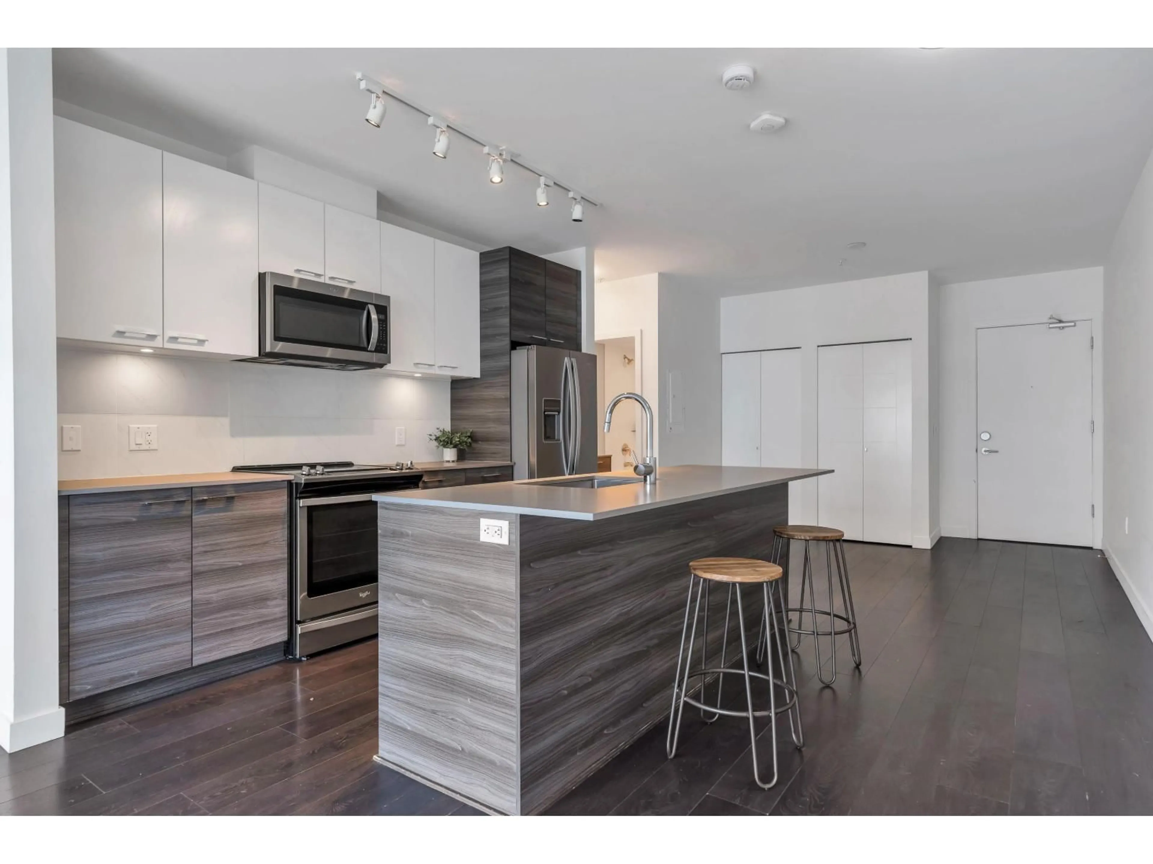 Open concept kitchen, wood/laminate floor for 401 - 10581 140 STREET, Surrey British Columbia V3T0M7
