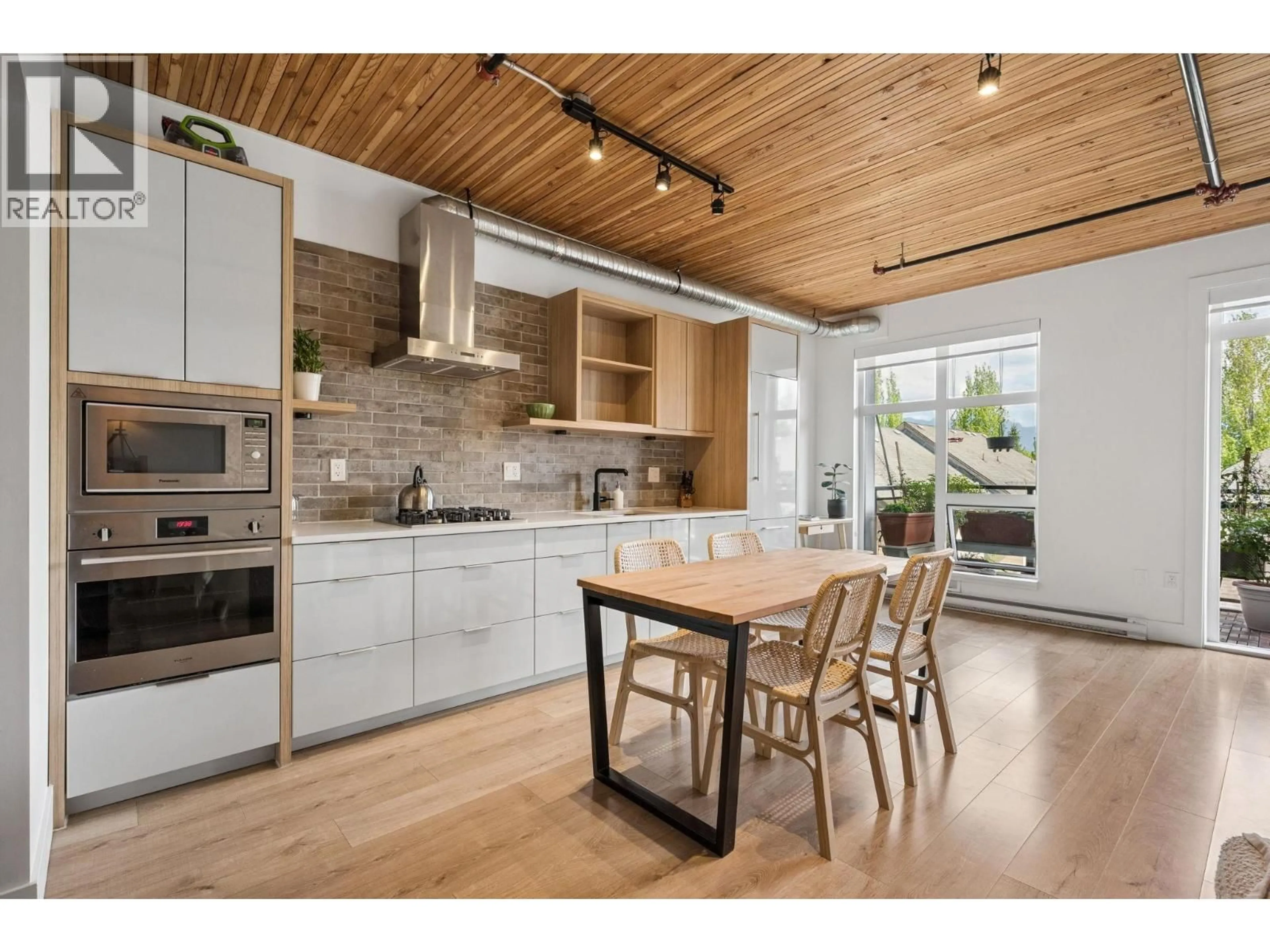 Open concept kitchen, wood/laminate floor for 305 - 4223 HASTINGS STREET, Burnaby British Columbia V5C2J5