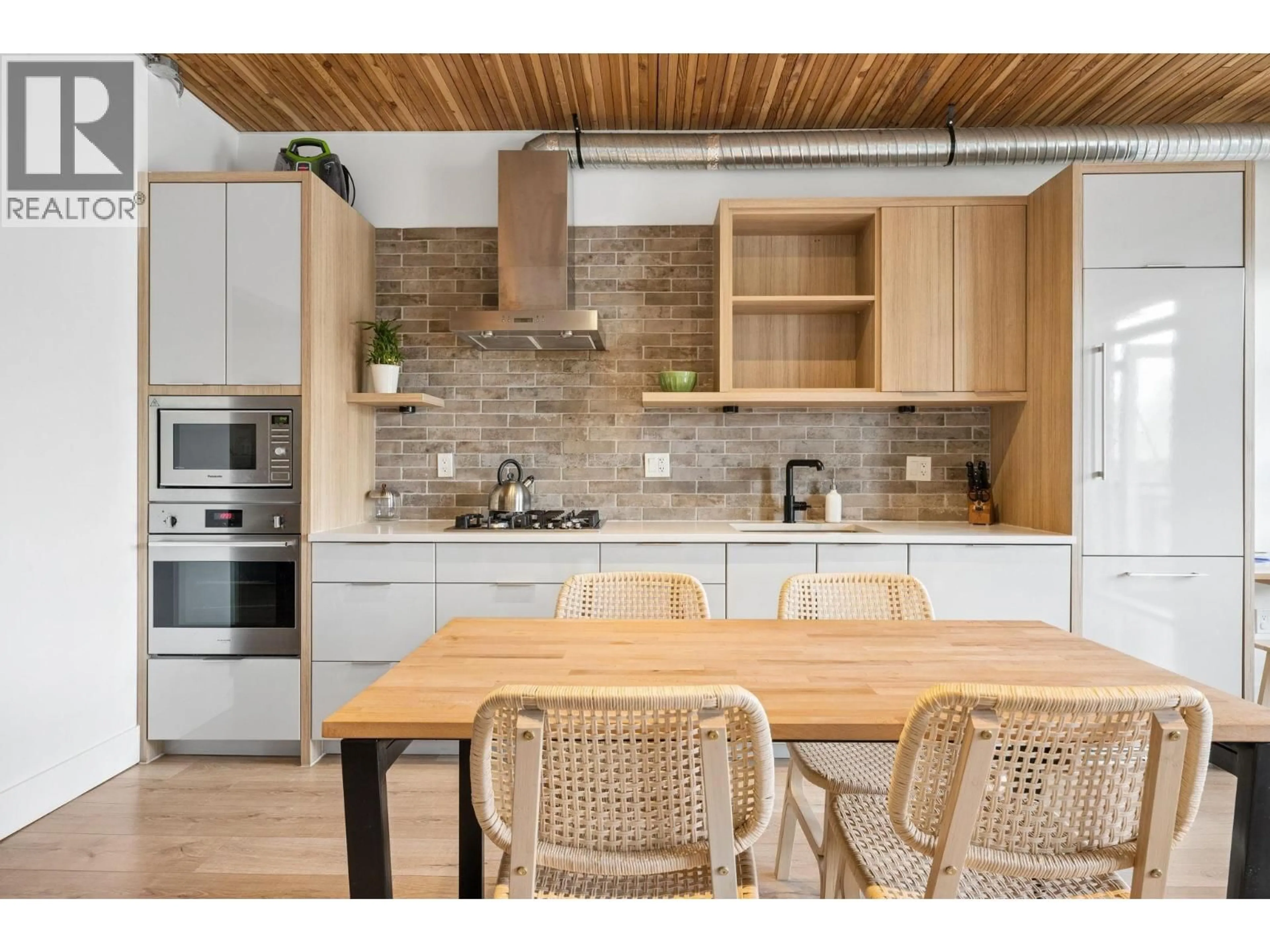 Open concept kitchen, wood/laminate floor for 305 - 4223 HASTINGS STREET, Burnaby British Columbia V5C2J5