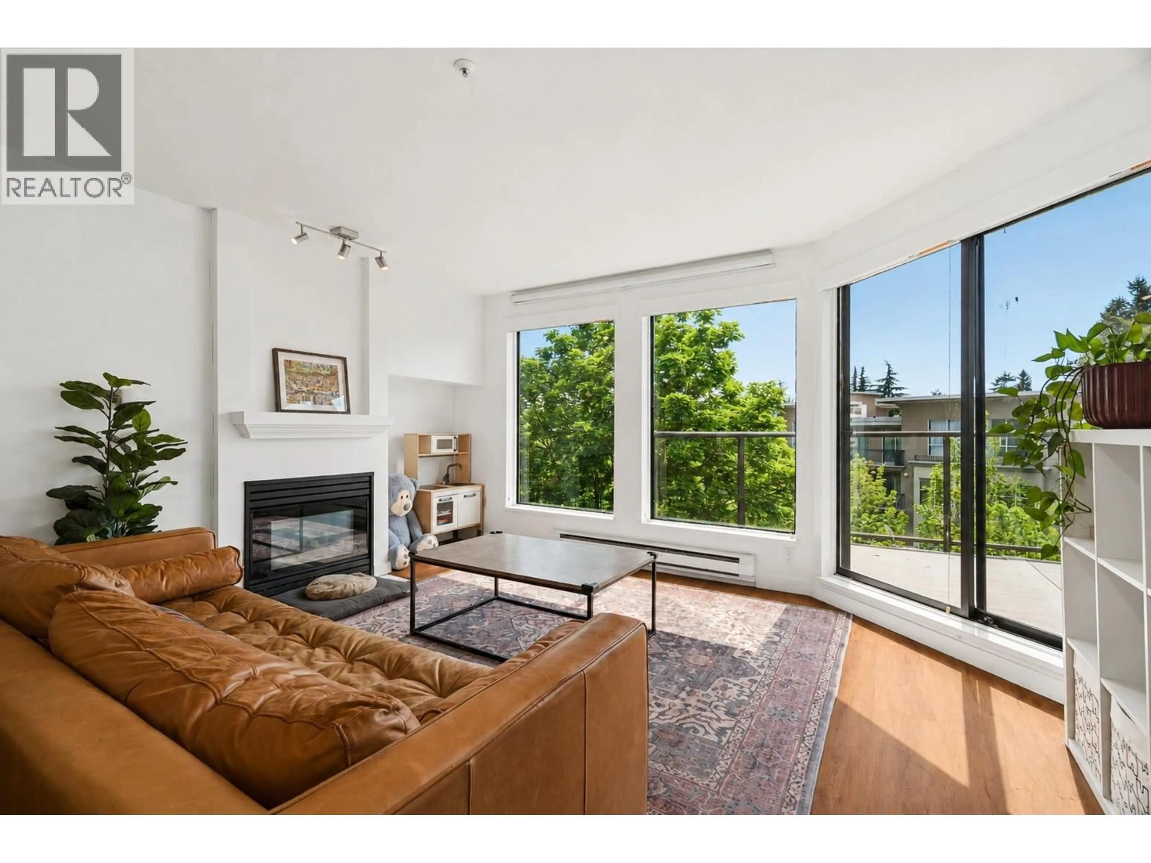 Living room with furniture, wood/laminate floor for 413 - 2968 BURLINGTON DRIVE, Coquitlam British Columbia V3B7N4