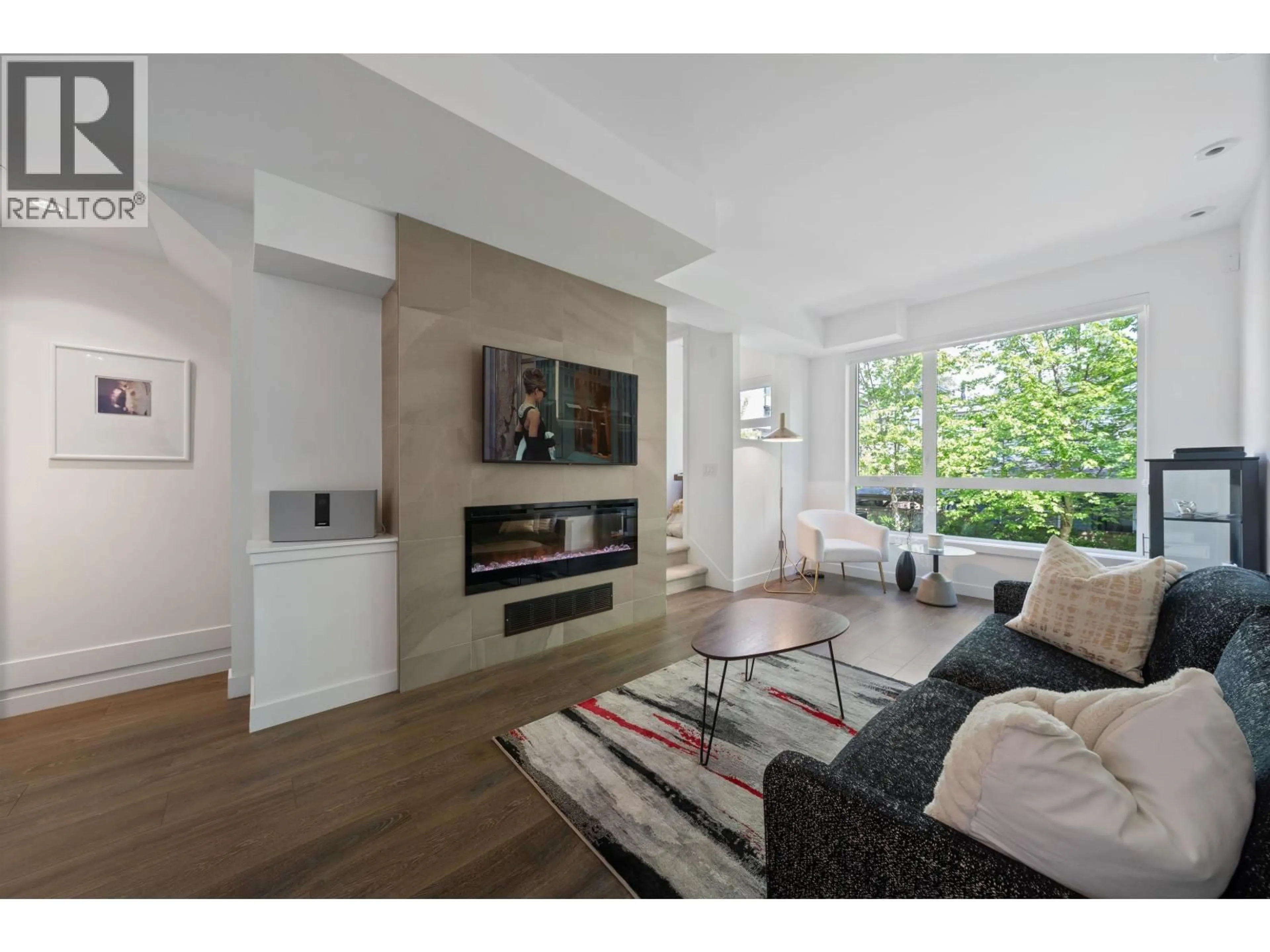 Living room with furniture, wood/laminate floor for 21 - 856 ORWELL STREET, North Vancouver British Columbia V7J0C2
