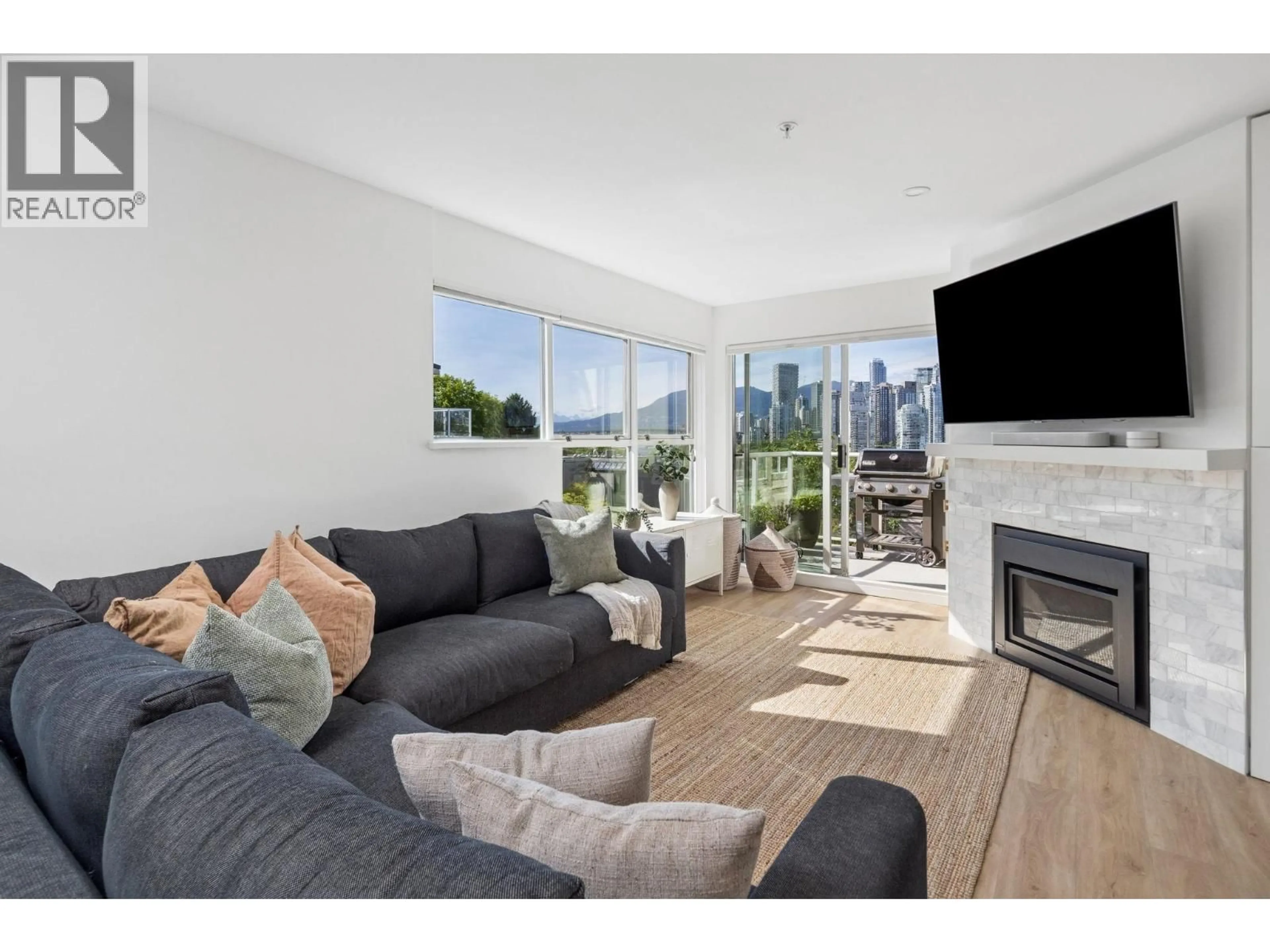 Living room with furniture, wood/laminate floor for 103 - 933 WEST 8TH AVENUE, Vancouver British Columbia V5Z1E4