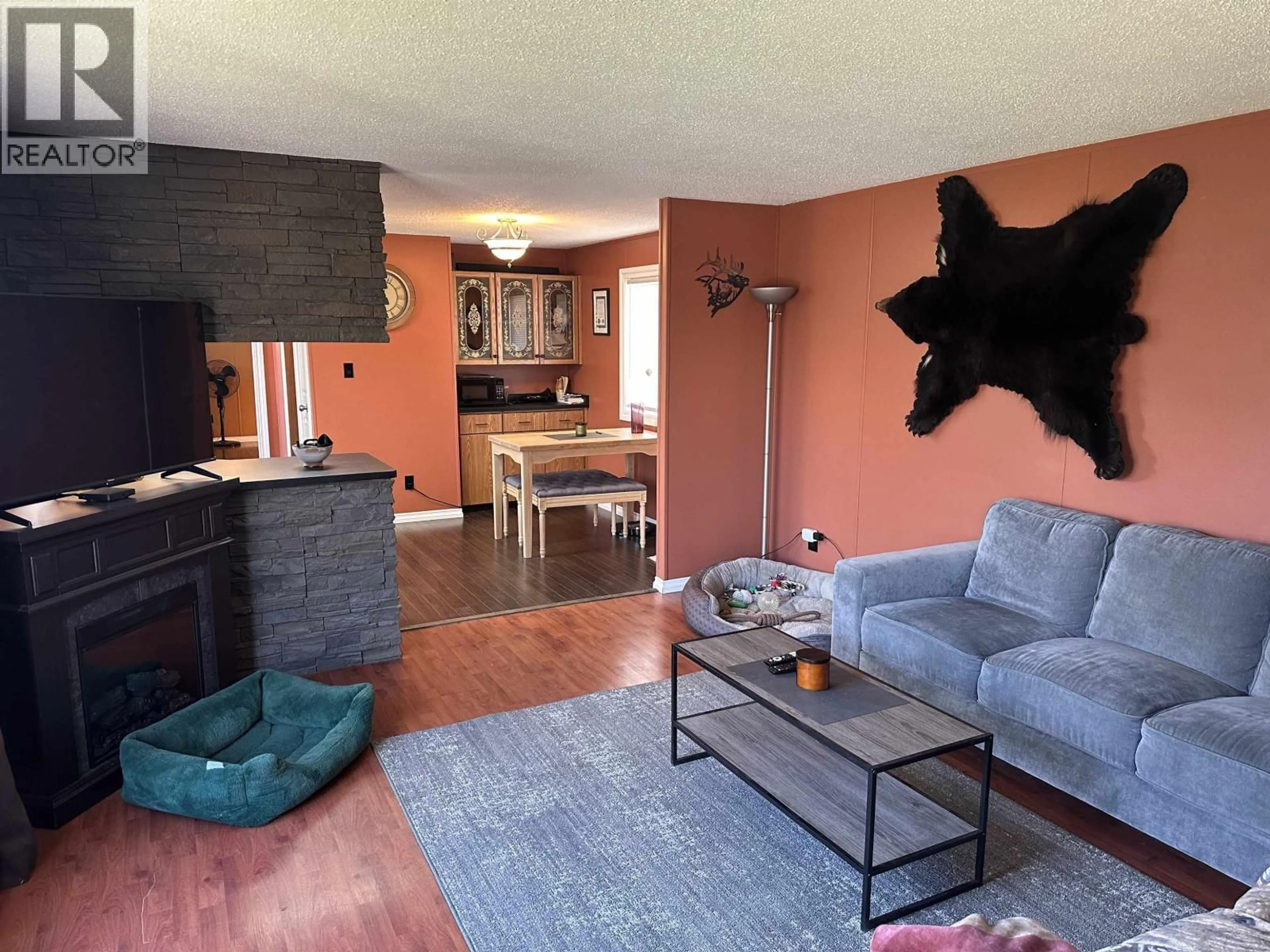 Living room with furniture, wood/laminate floor for 8708 76 STREET, Fort St. John British Columbia V1J2Z6