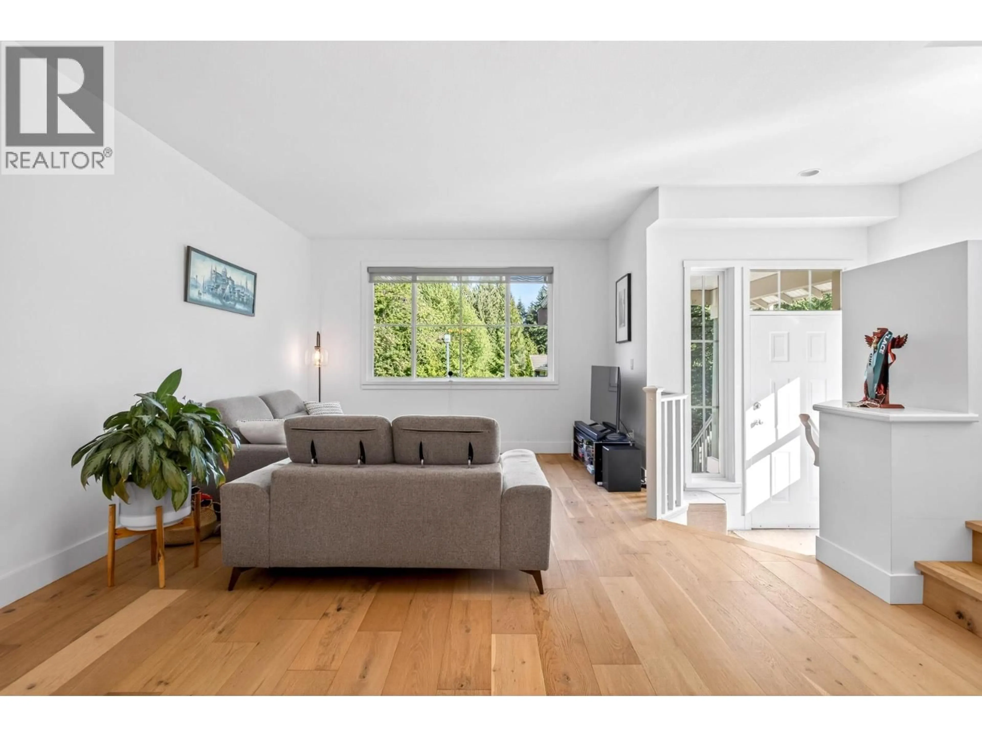 Living room with furniture, wood/laminate floor for 101 FOREST PARK WAY, Port Moody British Columbia V3H5J4